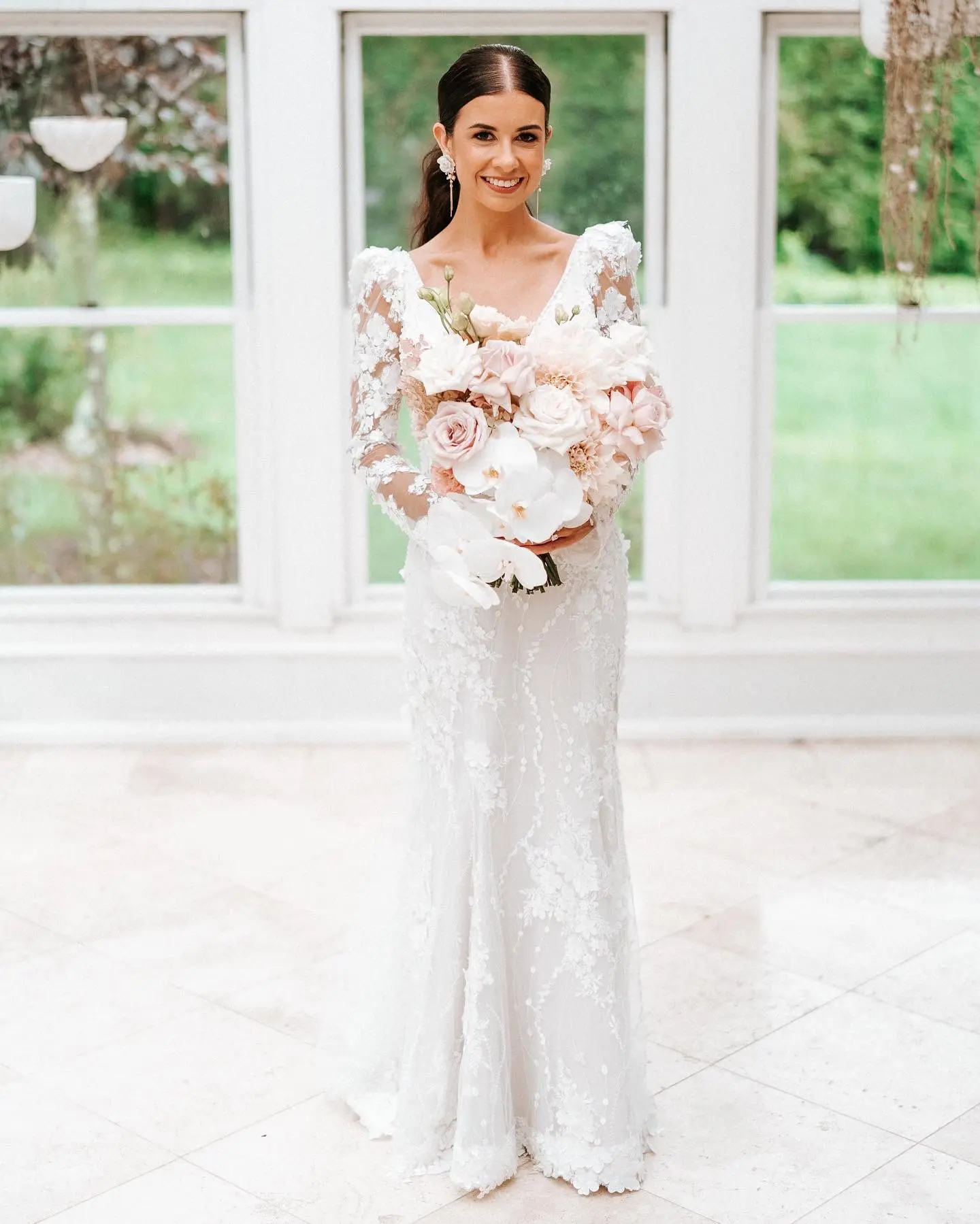 Real Bride wearing puff sleeve wedding dress with 3D floral details called Cruz by Sottero and Midgley..