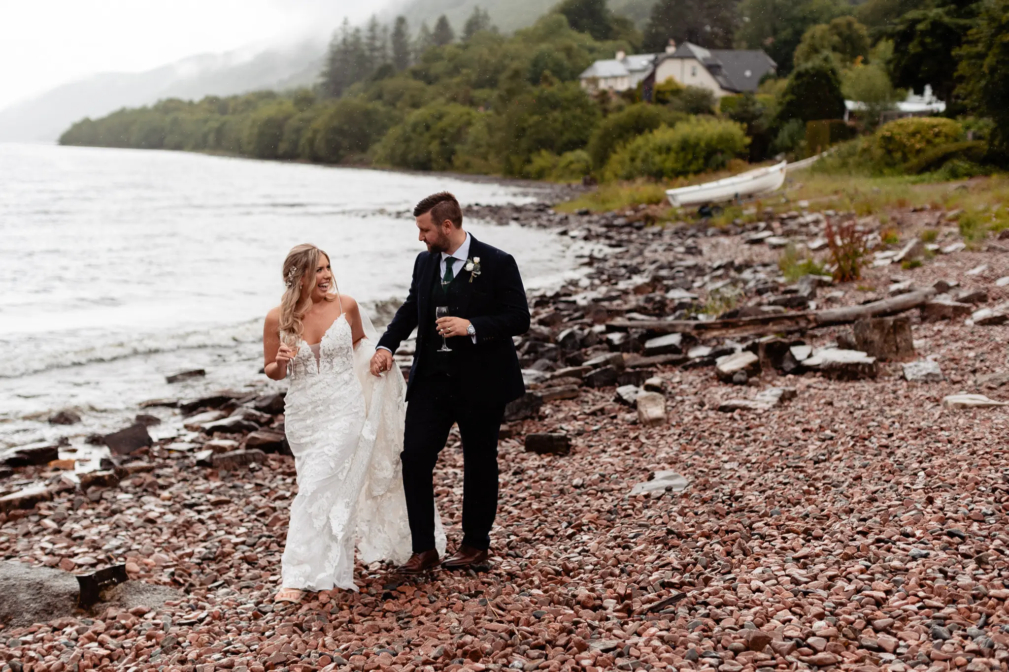 Bride and Groom Stroll the Beaches of Scotland. Bride in Romantic Lace Sheath Wedding Gown with Shimmering Lace Motifs Called Tuscany Lynette by Maggie Sottero