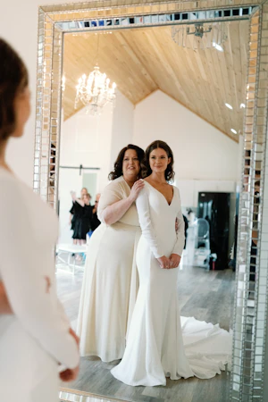 Bride wearing Fernanda wedding dress by Maggie Sottero looking in the mirror with her mother