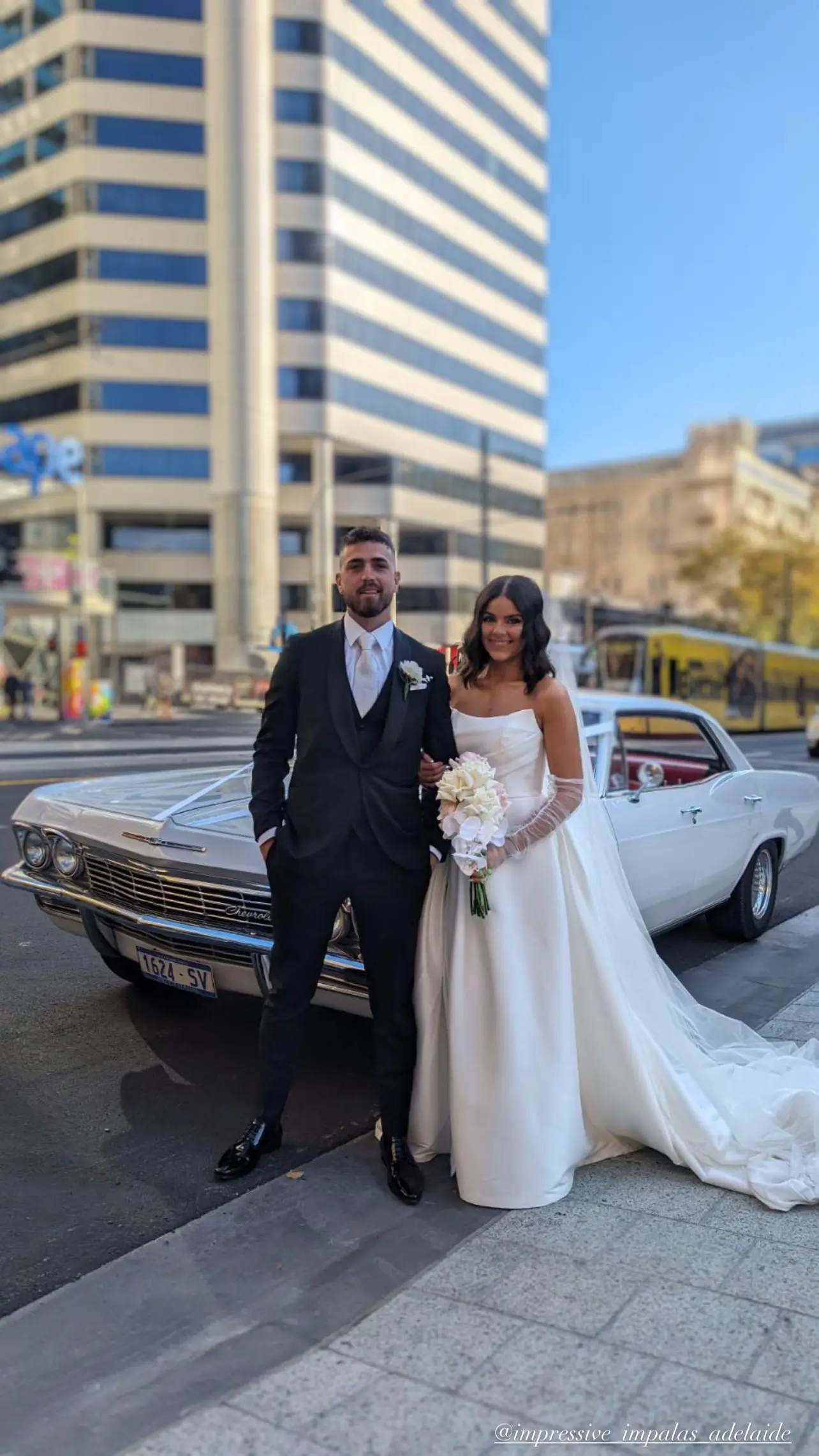 Bride wearing Aspen by Sottero and Midgley and her husband standing in front of a car