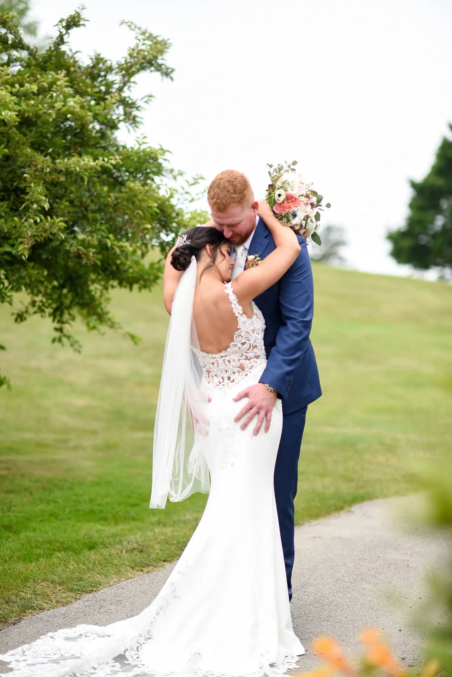 Bride with groom wearing crepe sheath wedding dress