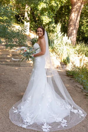 Bride Wearing Lace Mermaid Wedding Dress Called Hattie By Rebecca Ingram In A Garden