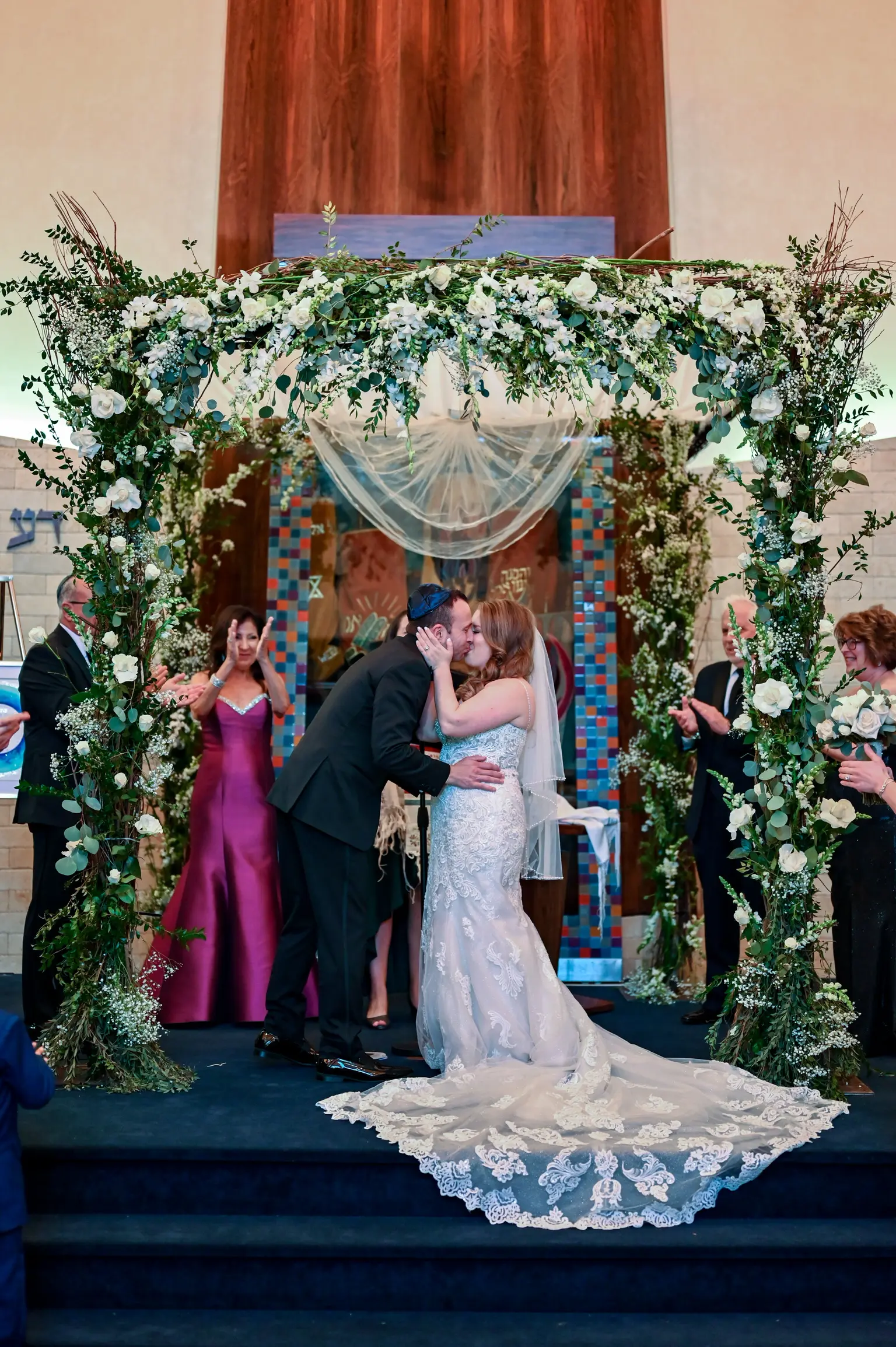 Bride Wearing Lace Fit-And-Flare Wedding Dress Called Fiona By Maggie Sottero Kissing Groom