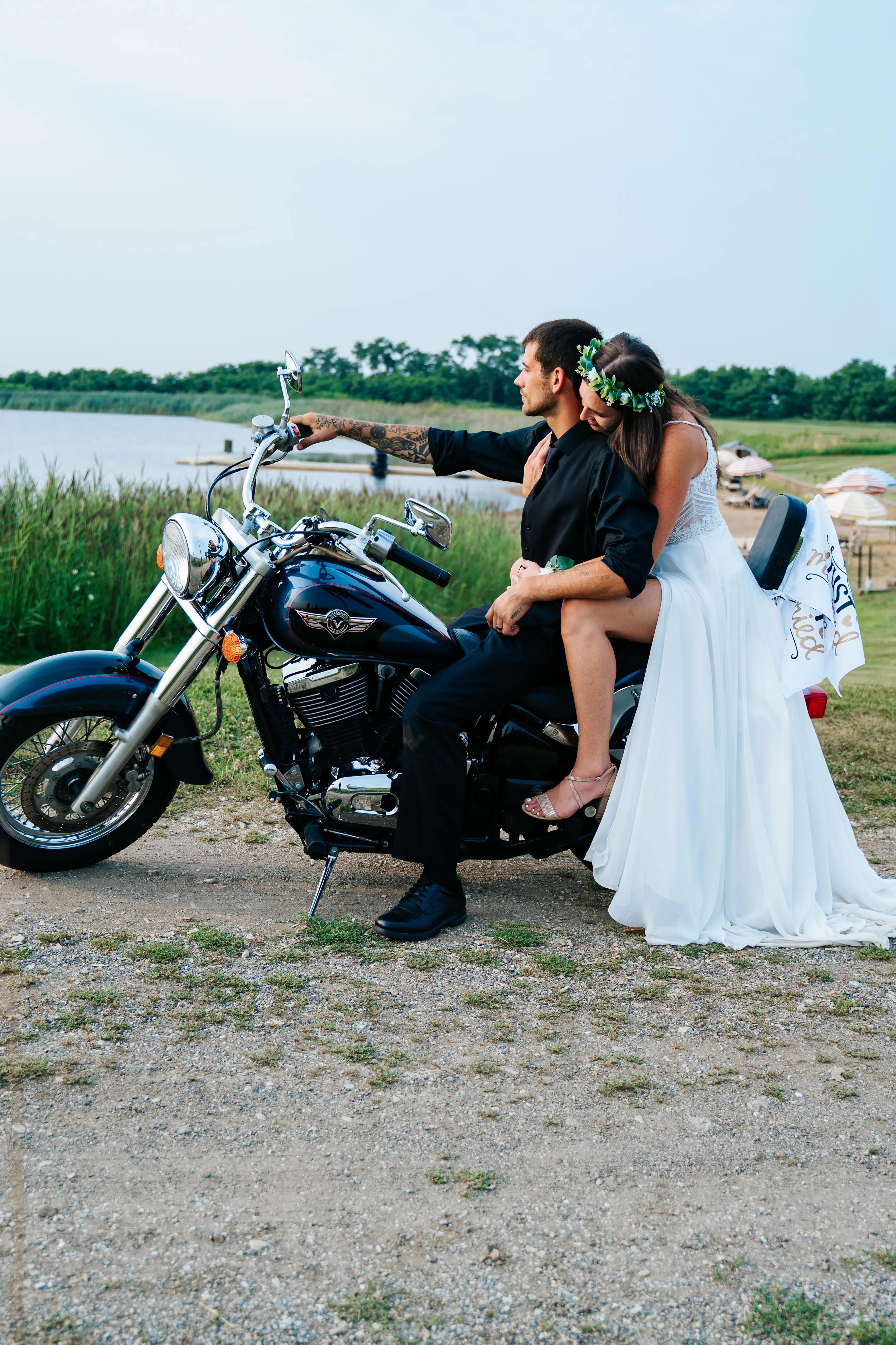 Bride Wearing Sheath Wedding Dress Called Lorraine By Rebecca Ingram On A Motorcycle With Groom