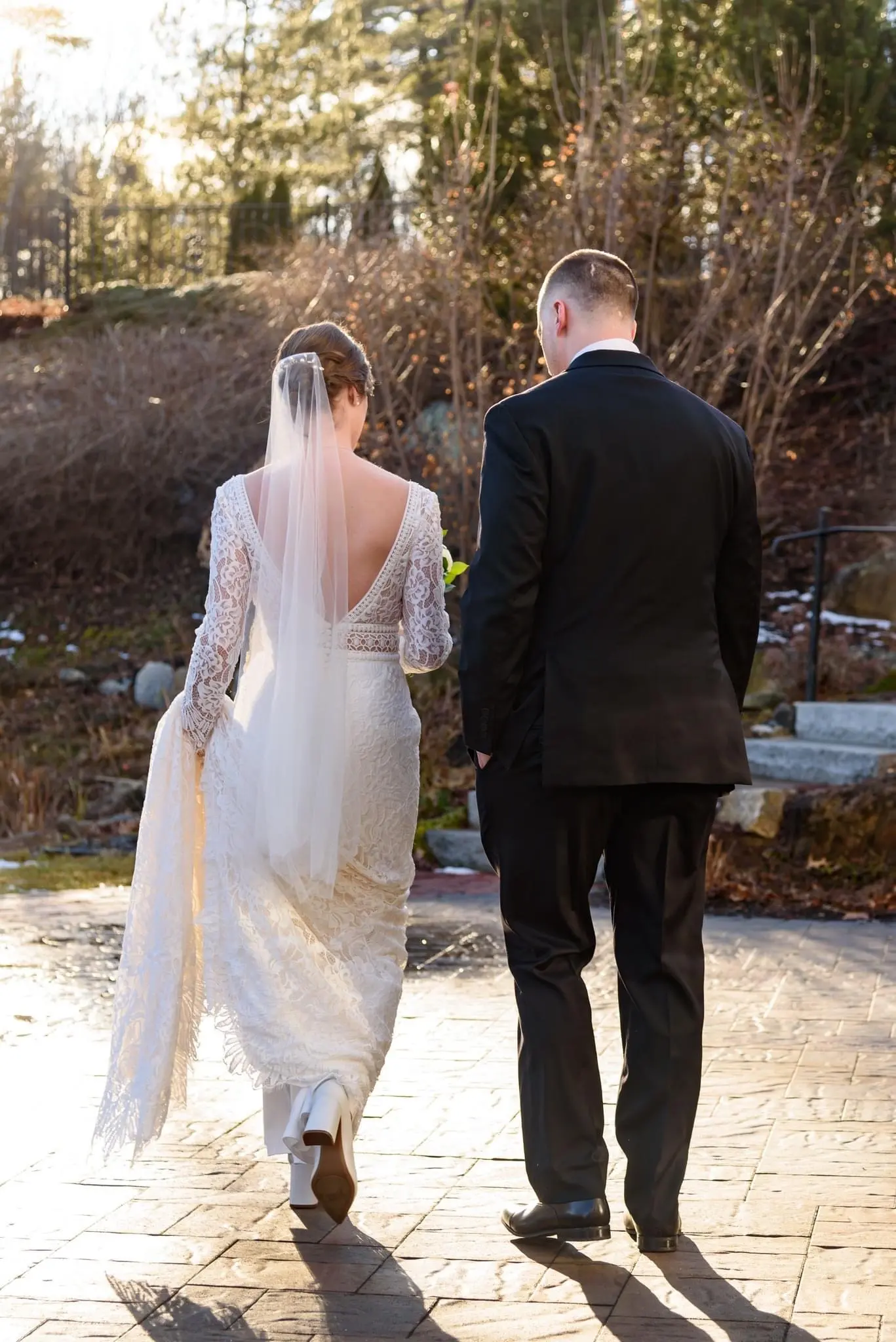 Bride Wearing Boho Sleeved Wedding Dress Called Drita By Maggie Sottero Walking With Groom