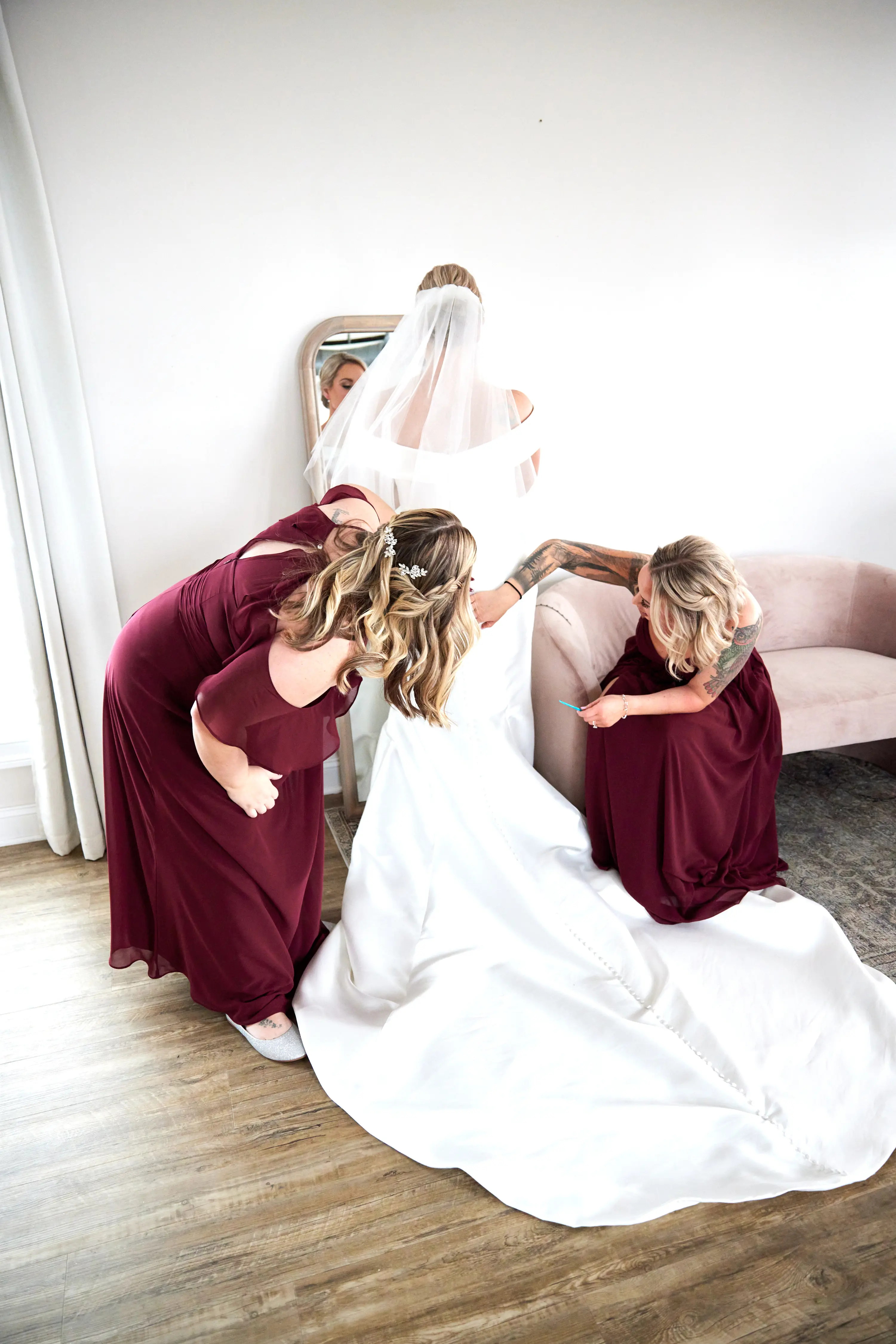 Bridesmaids Helping Bride with Wedding Gown Called Josie by Rebecca Ingram.