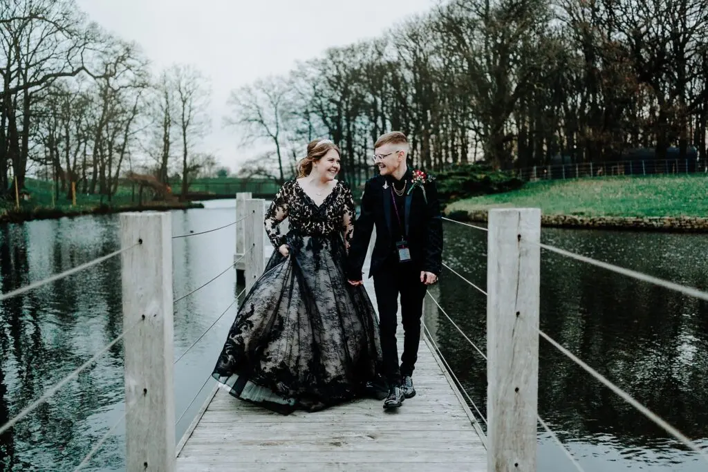 Bride Wearing Gothic Black Wedding Dress Called Zander By Maggie Sottero And Groom Walking