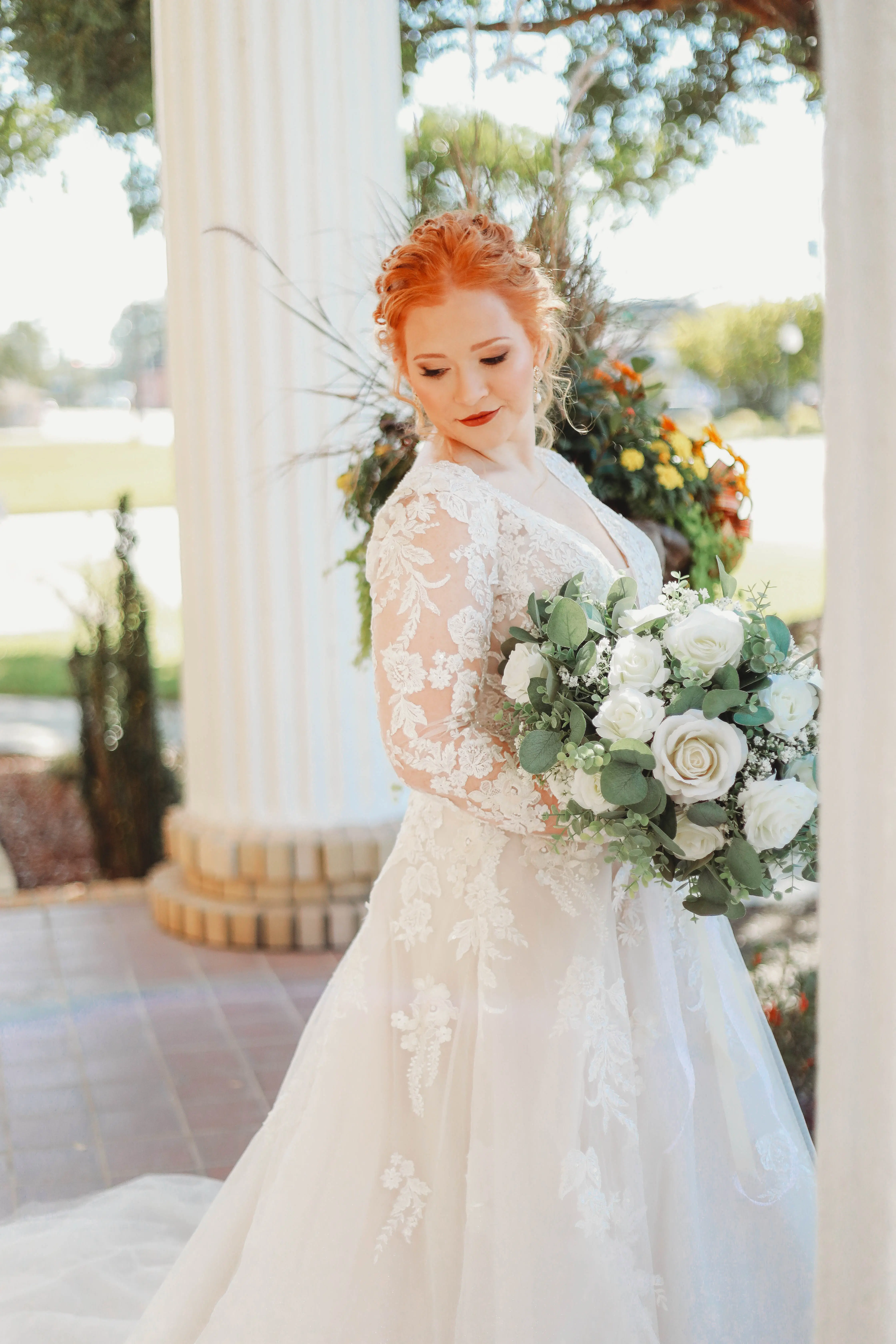 Bride Wearing Lace Long-Sleeve Wedding Gown Called Raphael By Maggie Sottero With Bouquet