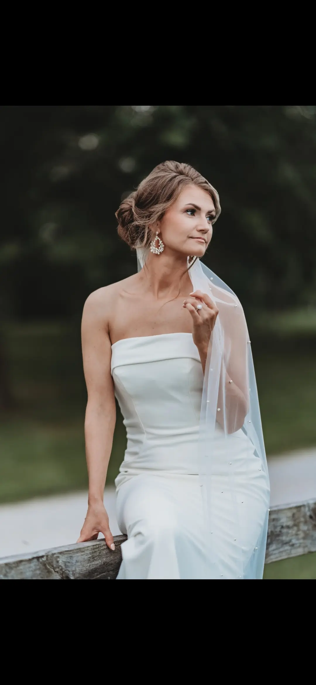 Bride Wearing Simple Fit And Flare Wedding Dress Called Francine By Rebecca Ingram With A Pearl Accented Veil