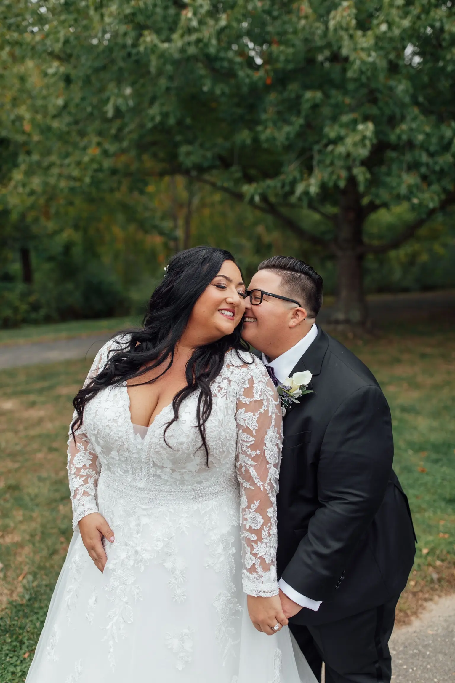 Bride Wearing Vintage Royalty Long Sleeve Wedding Dress Called Raphael By Maggie Sottero Cuddling With Groom Outside Holding Hands