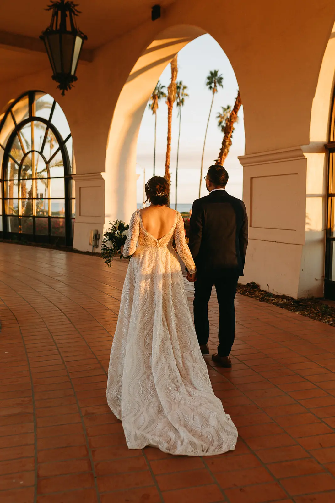 Bride Wearing Boho Lace Wedding Dress Called Roxanne By Sottero And Midgley And Groom Walking In The Sunset