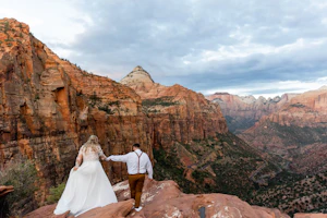Real Bride in Long Sleeved, Thigh-High Slit Wedding Dress Named Lorraine by Rebecca Ingram with Groom