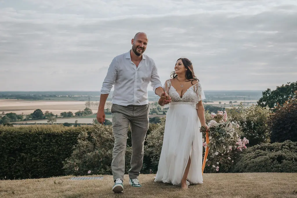 Bride wearing Lorraine by Rebecca Ingram with her husband
