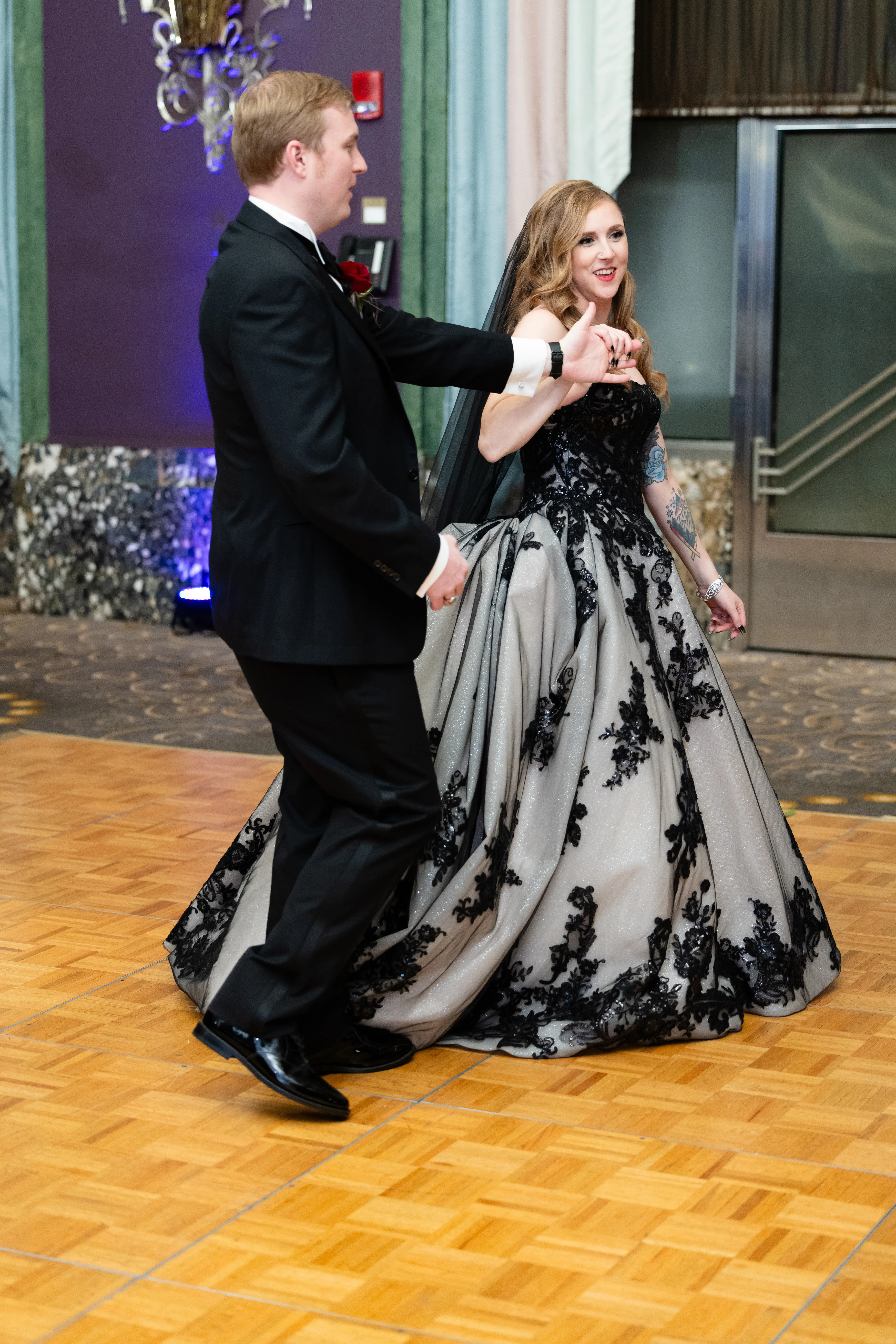 Bride wearing Norvinia wedding dress by Sottero and Midgley dancing with her husband