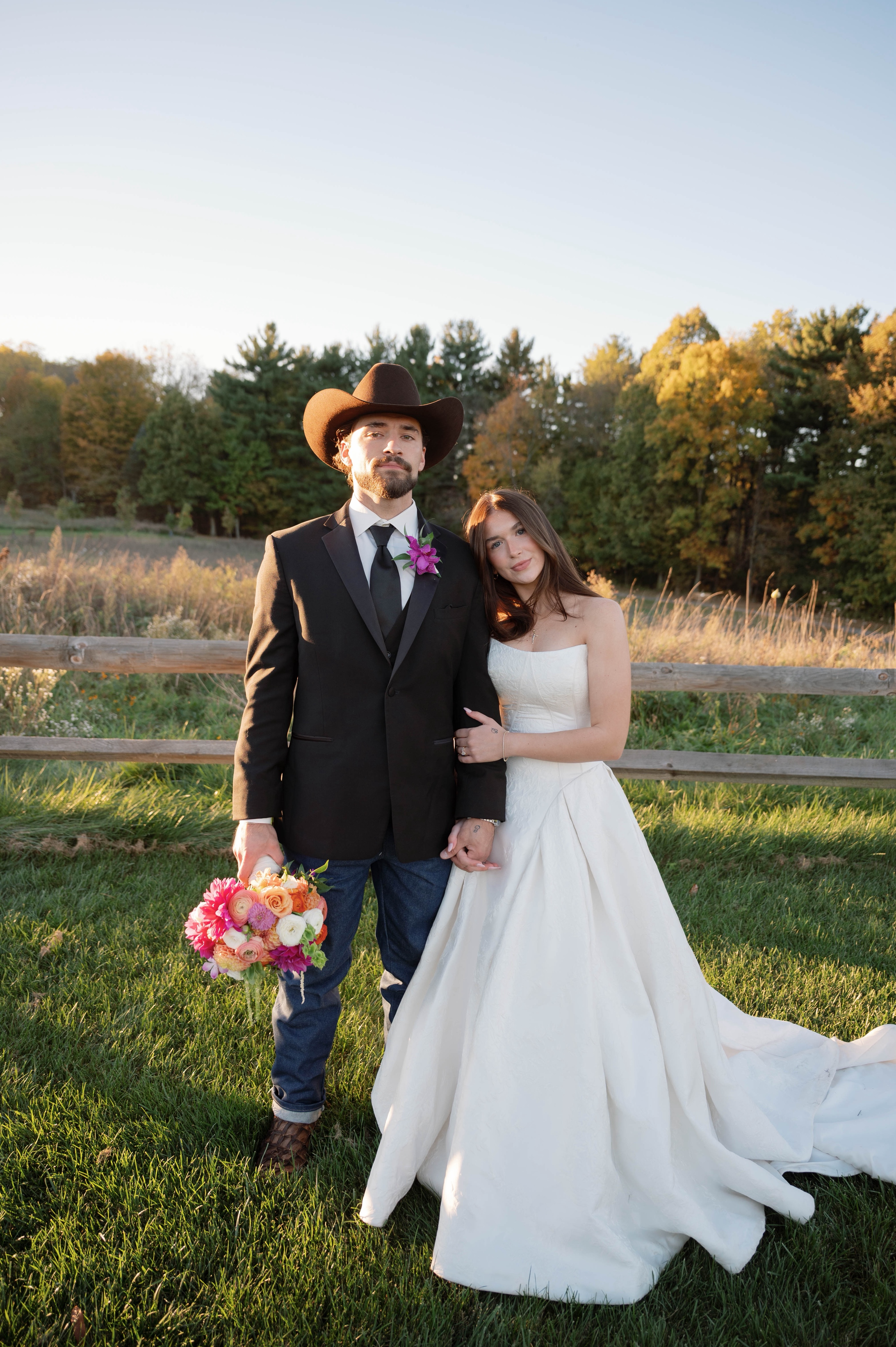 Bride Wearing Jacquard Ballgown Wedding Dress Called Fortune Marie By Maggie Sottero With groom in a field
