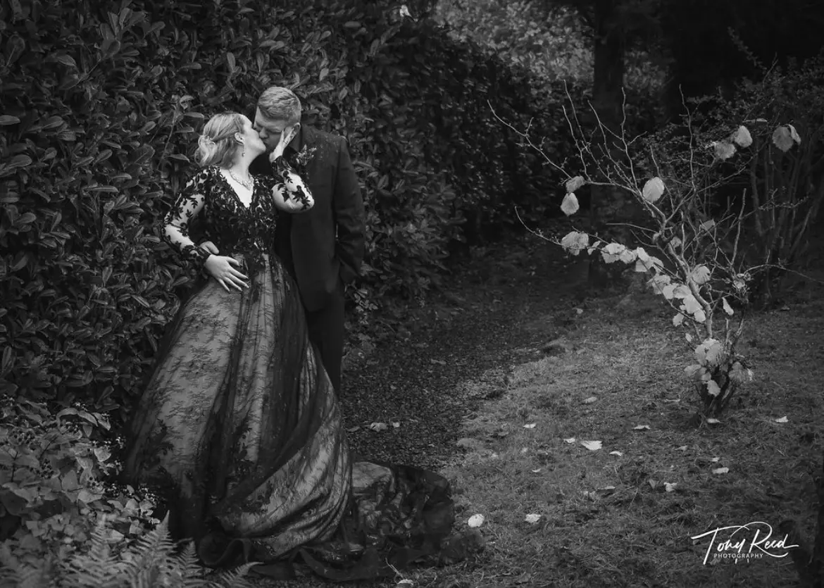 Groom Kissing Bride In A Black Lace Ball Gown Wedding Dress Named Zander By Sottero And Midgley