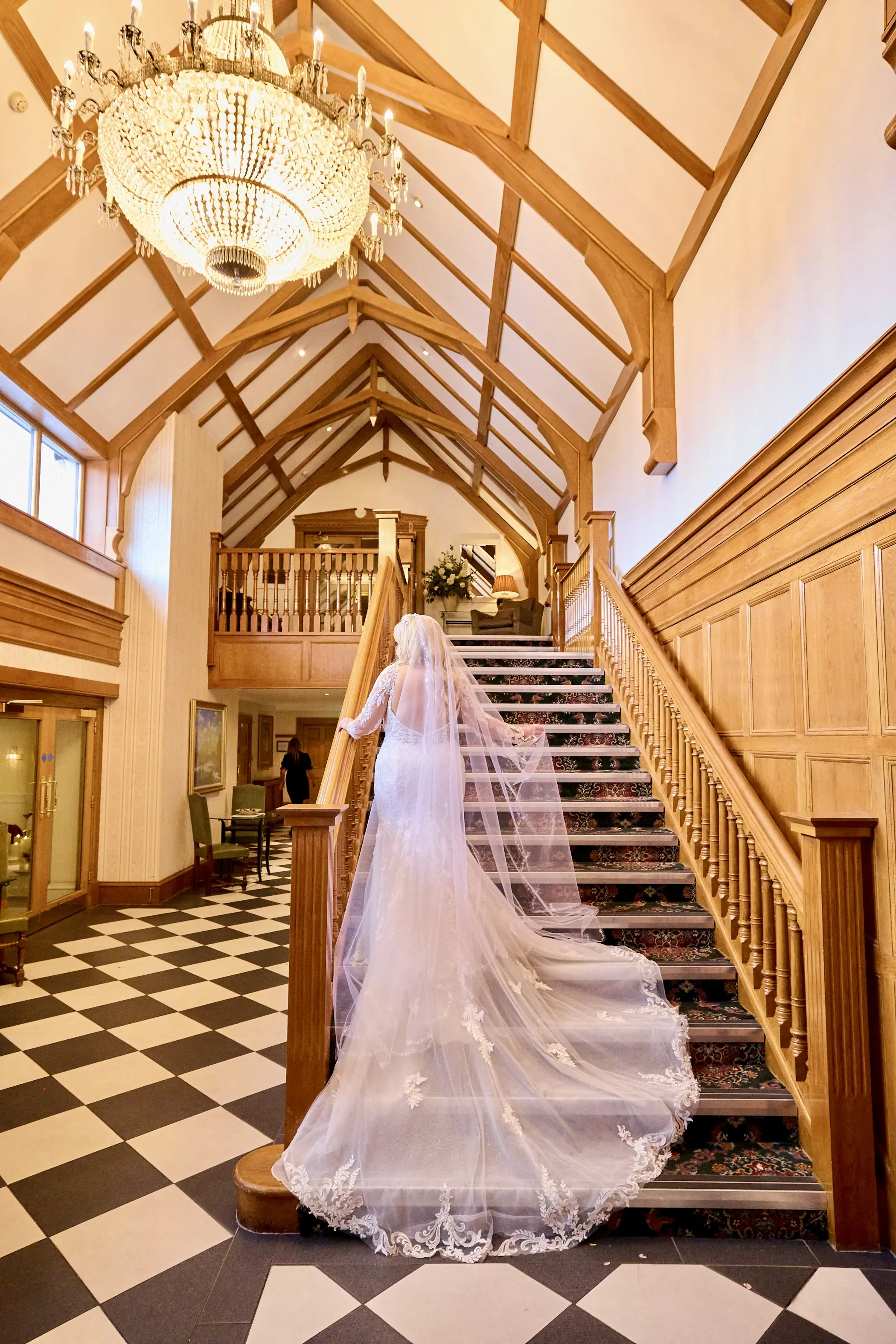 Bride wearing Saige by Maggie Sottero walking up the stairs