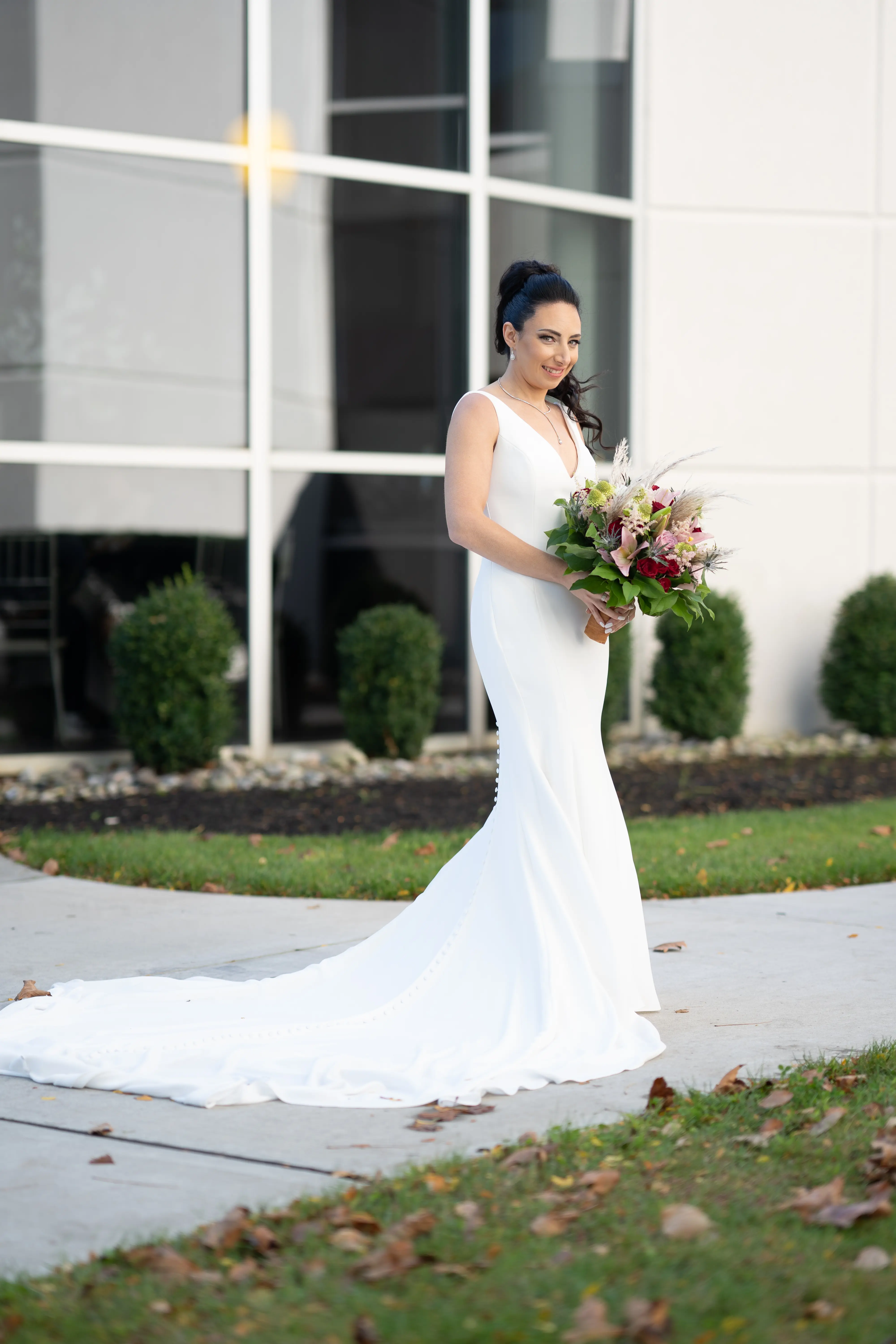 Bride wearing simple fit and flare crepe wedding dress