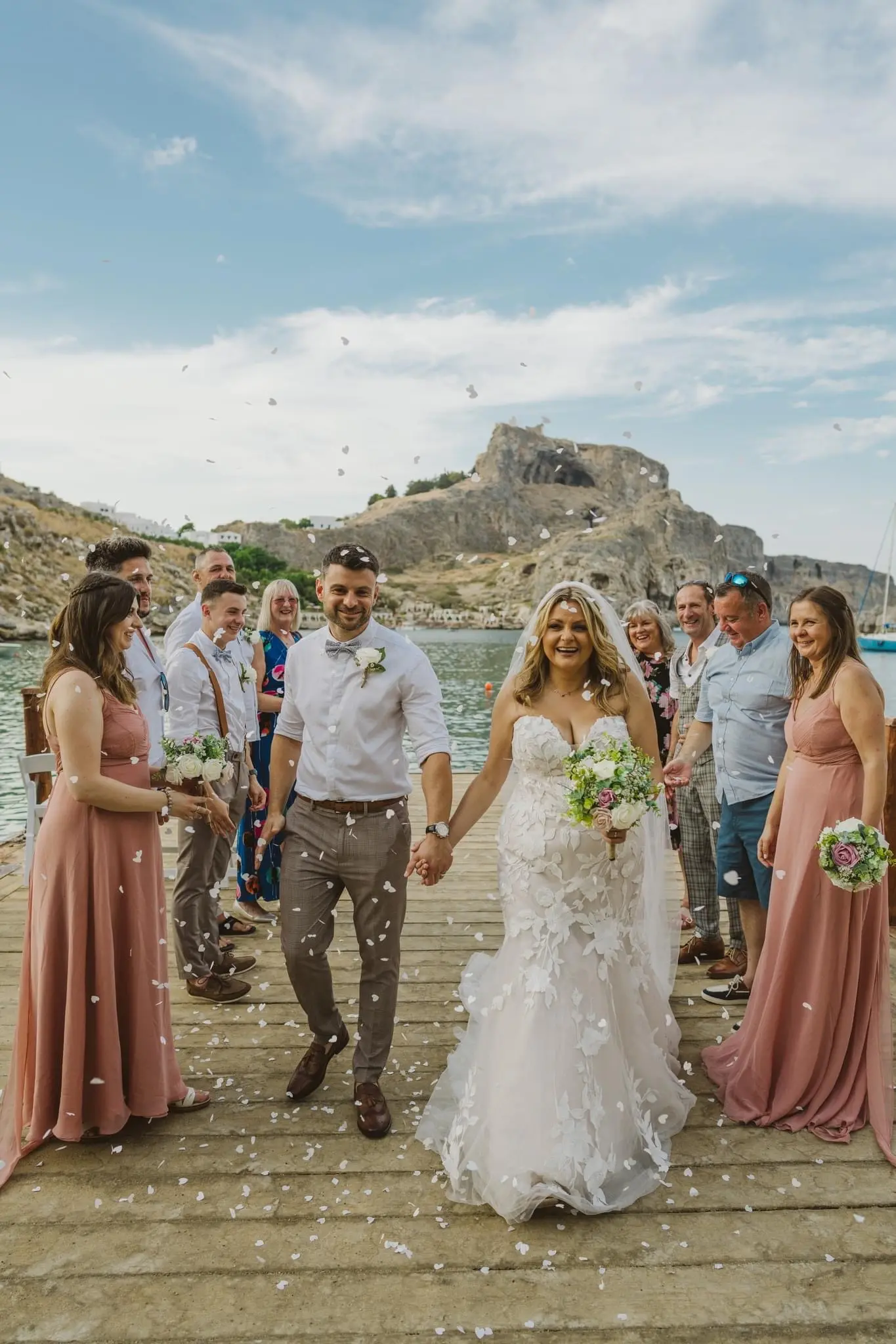 Bride wearing Hattie wedding dress by Rebecca Ingram during her exit with groom