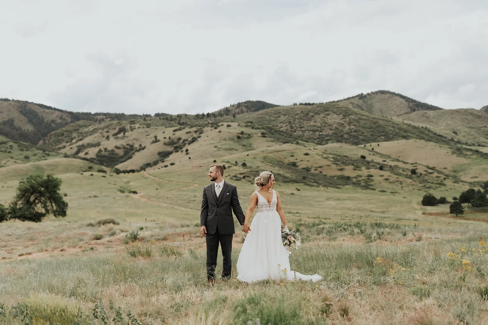 Bride In Lace Backless Wedding Dress Called Raelynn By Rebecca Ingram With Groom