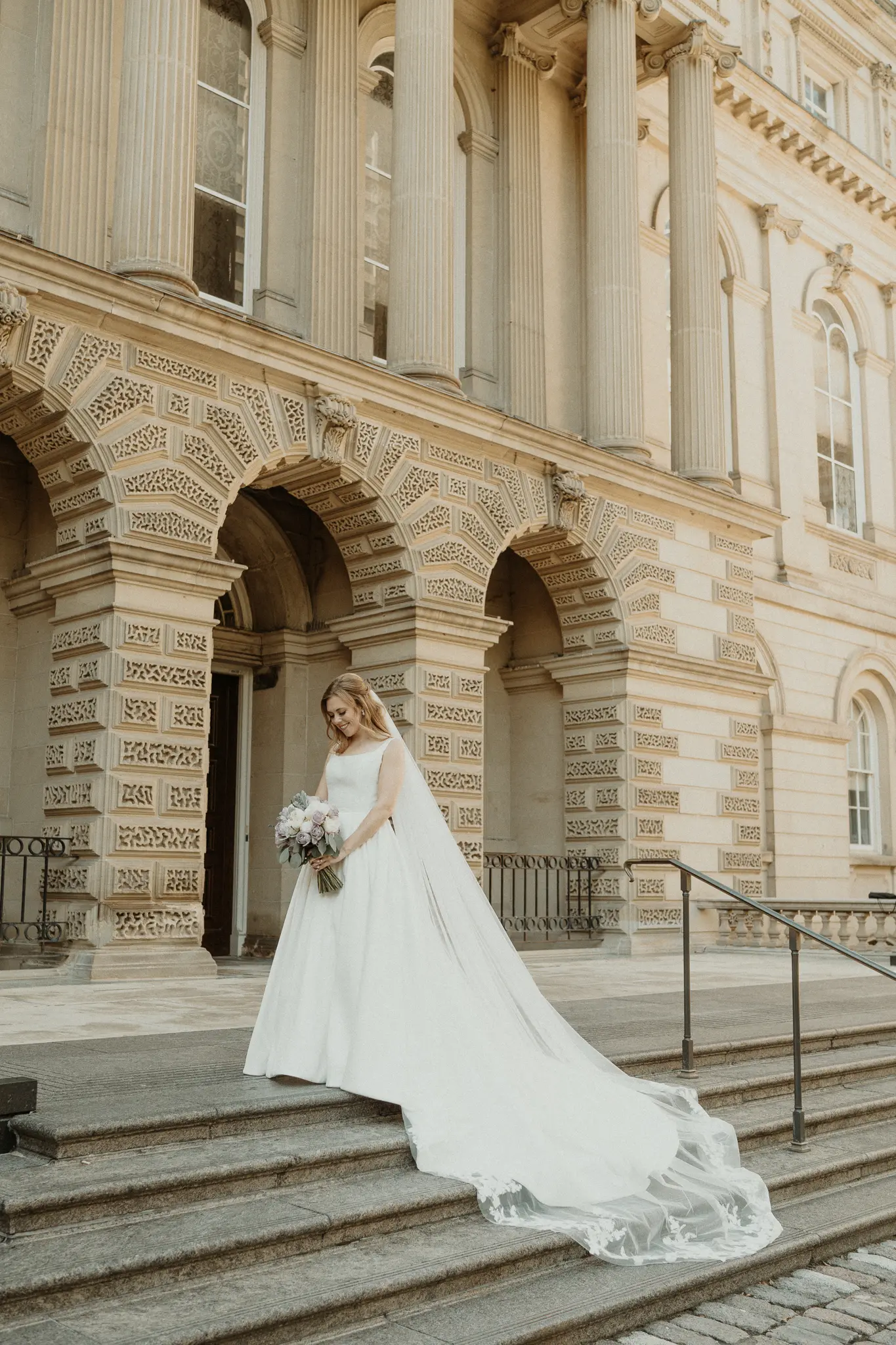 Bride wearing Selena wedding gown by Maggie Sottero on the stairs