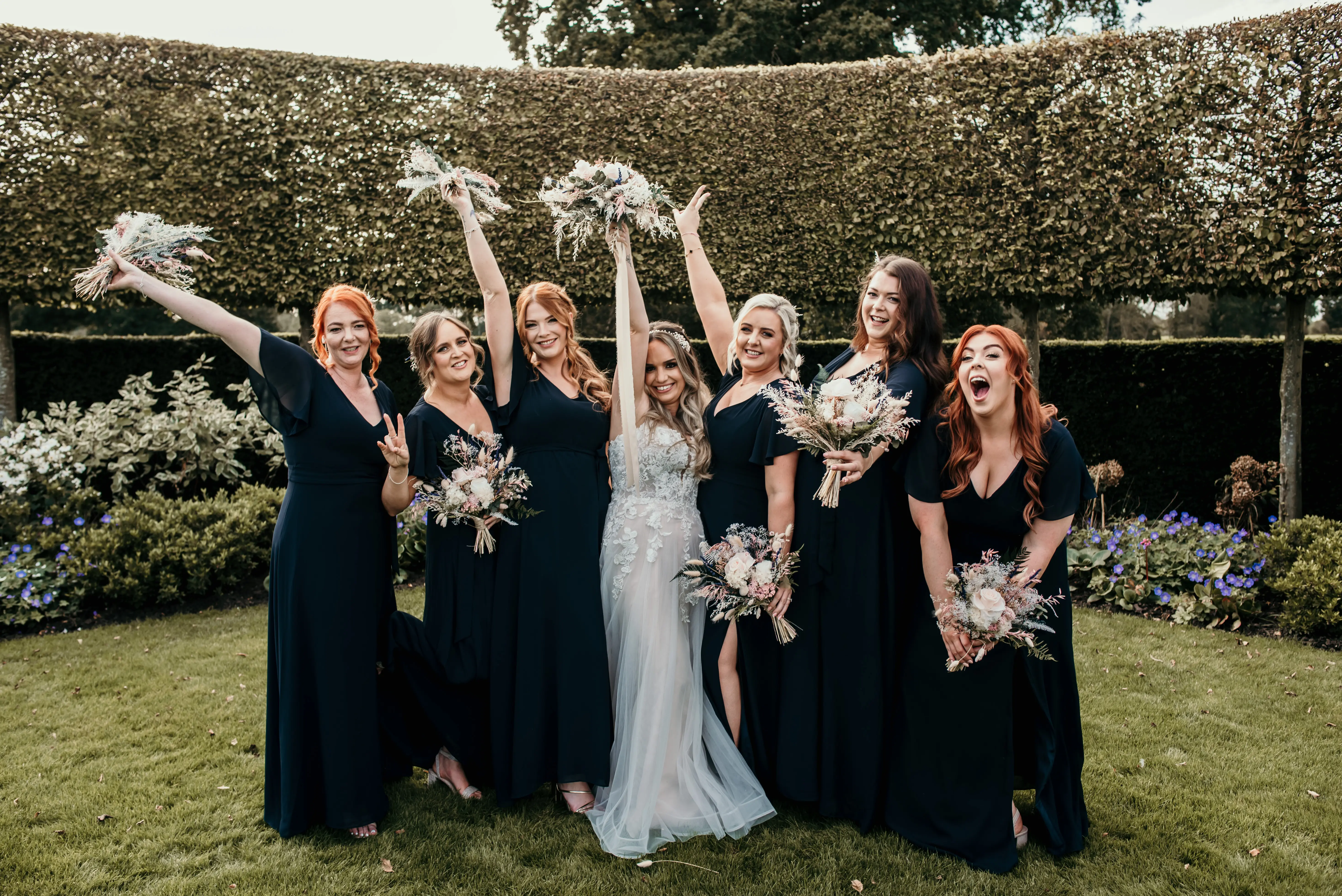 Bride wearing Stevie wedding gown by Maggie Sottero with her bridesmaids
