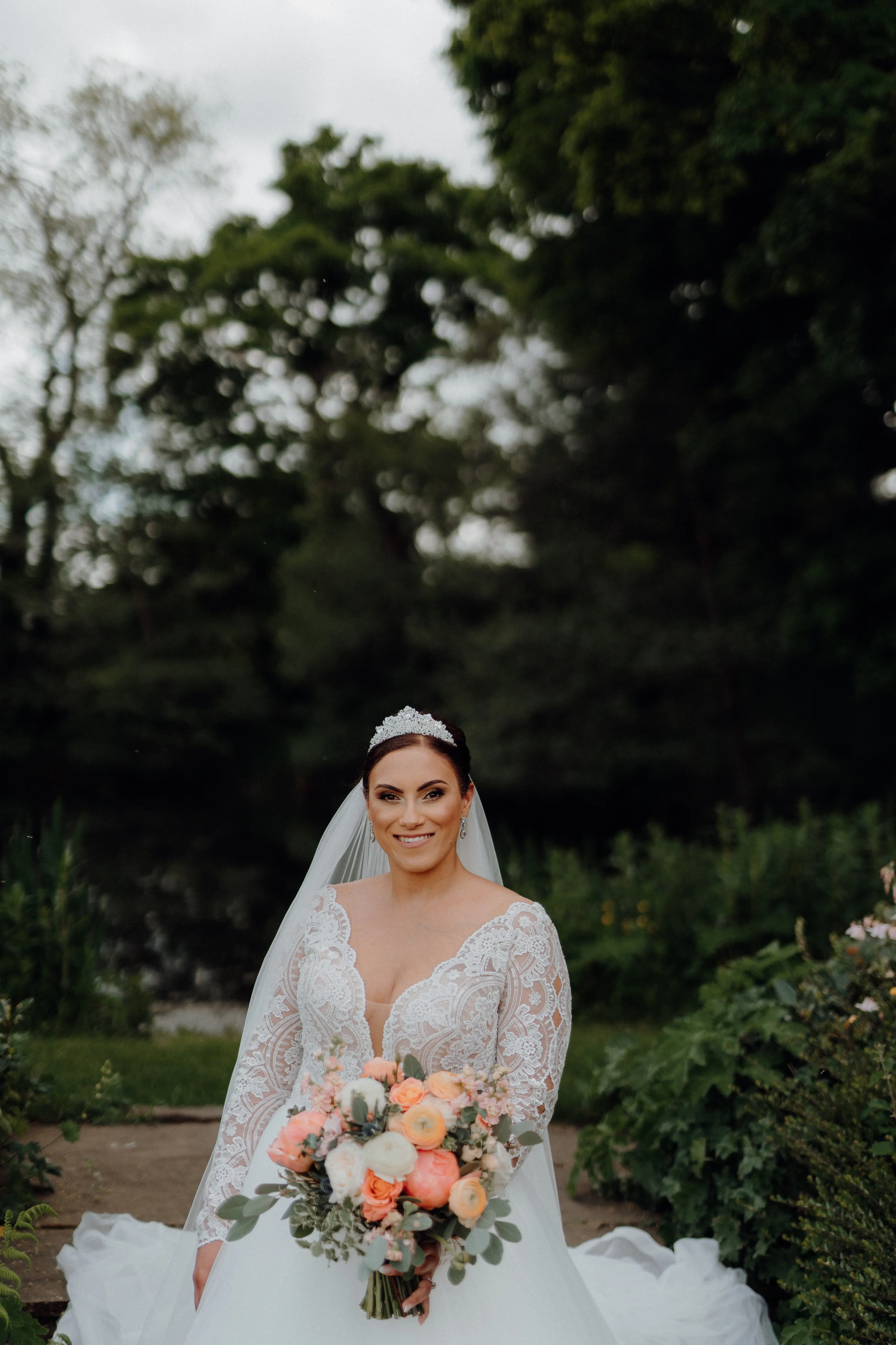 Bride In Long Sleeve Lace Ball Gown Wedding Dress Called Mallory Dawn By Maggie Sottero With Crown And Bouquet
