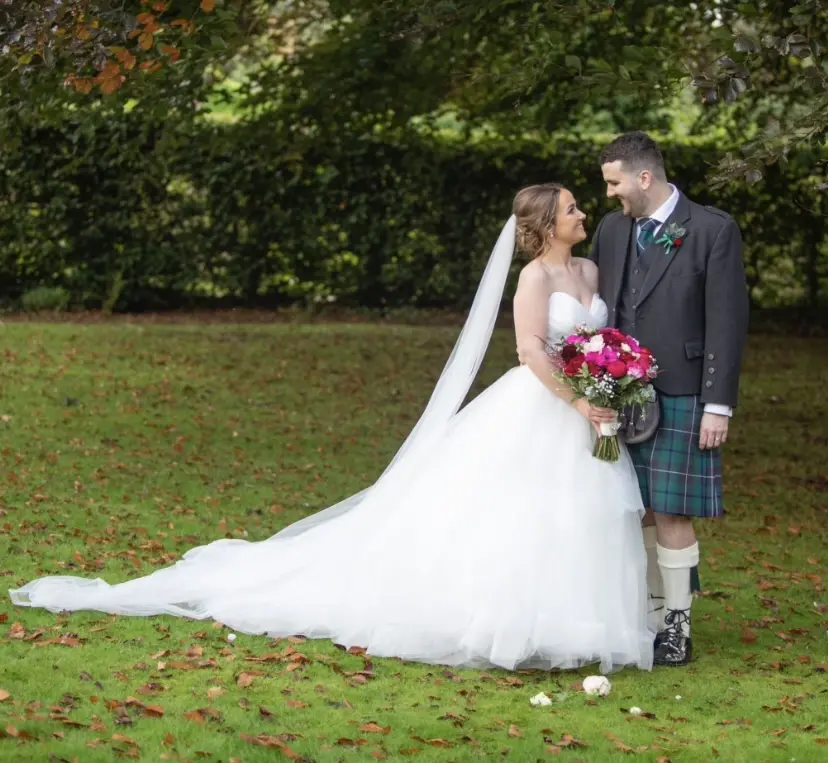 Groom With Bride Wearing Ball Gown With Tiered Skirt Yasmin By Maggie Sottero