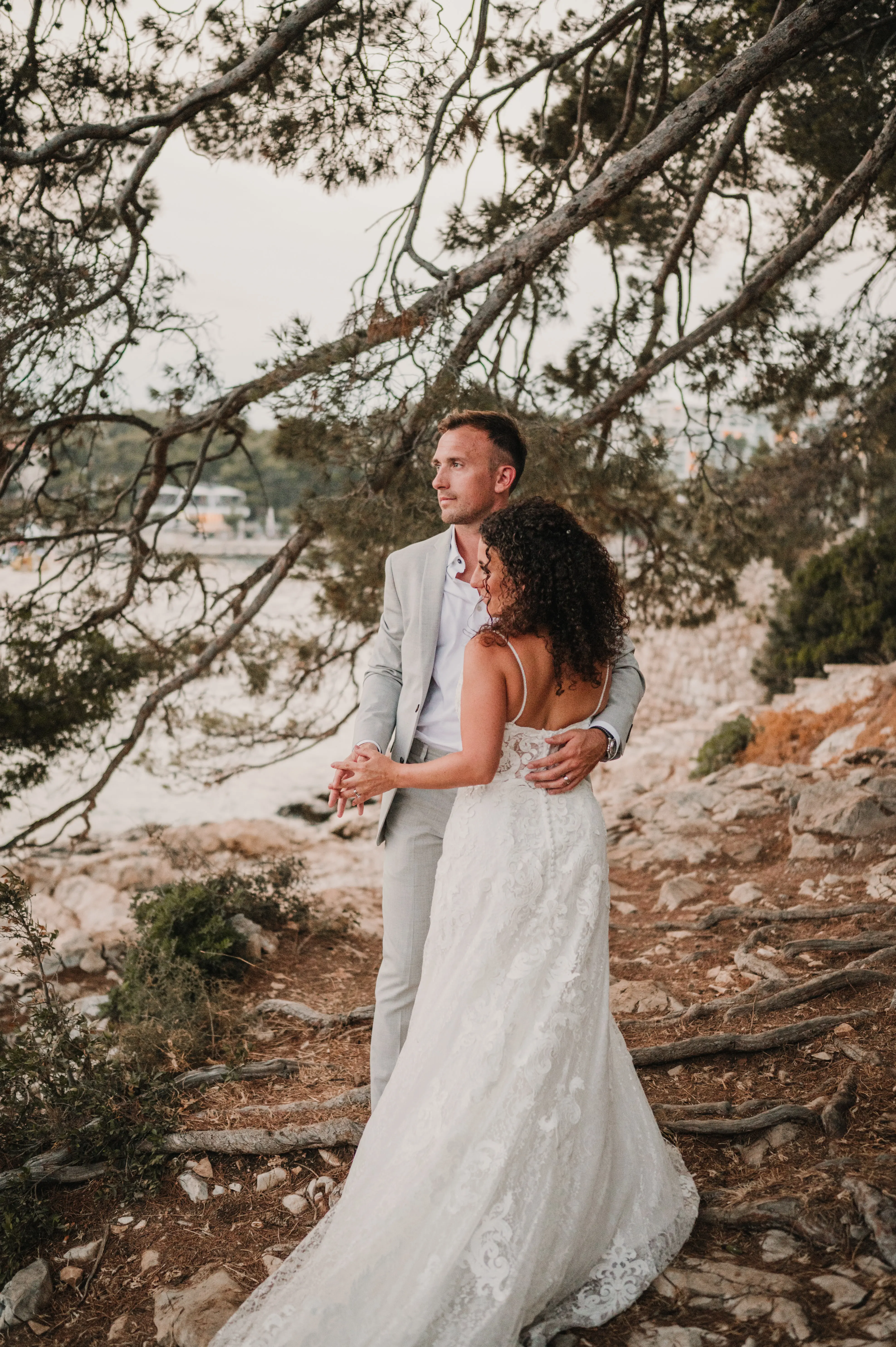 Bride with groom wearing flattering lace A-line wedding dress