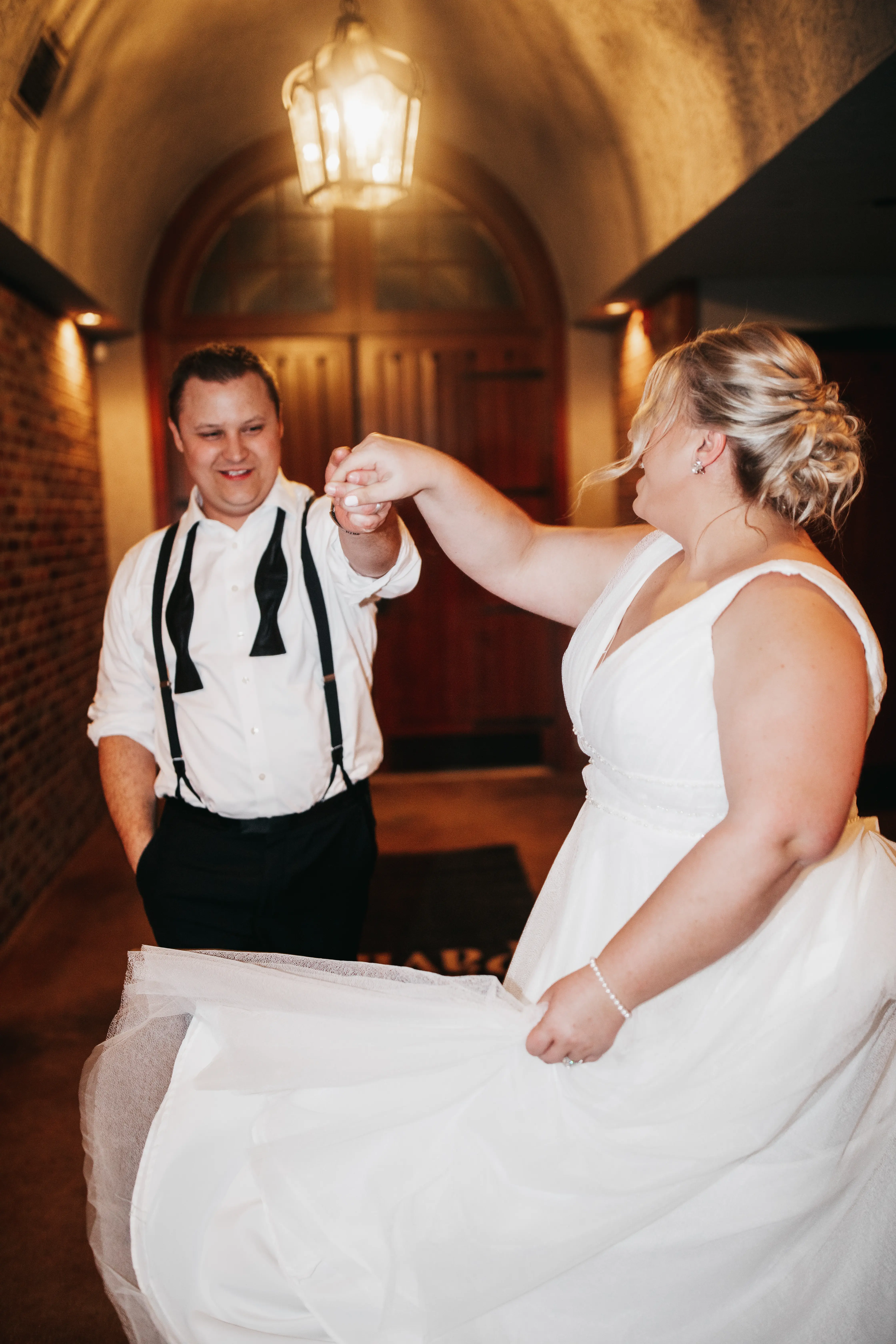 Bride wearing Joanne wedding dress by Rebecca Ingram dancing with her husband