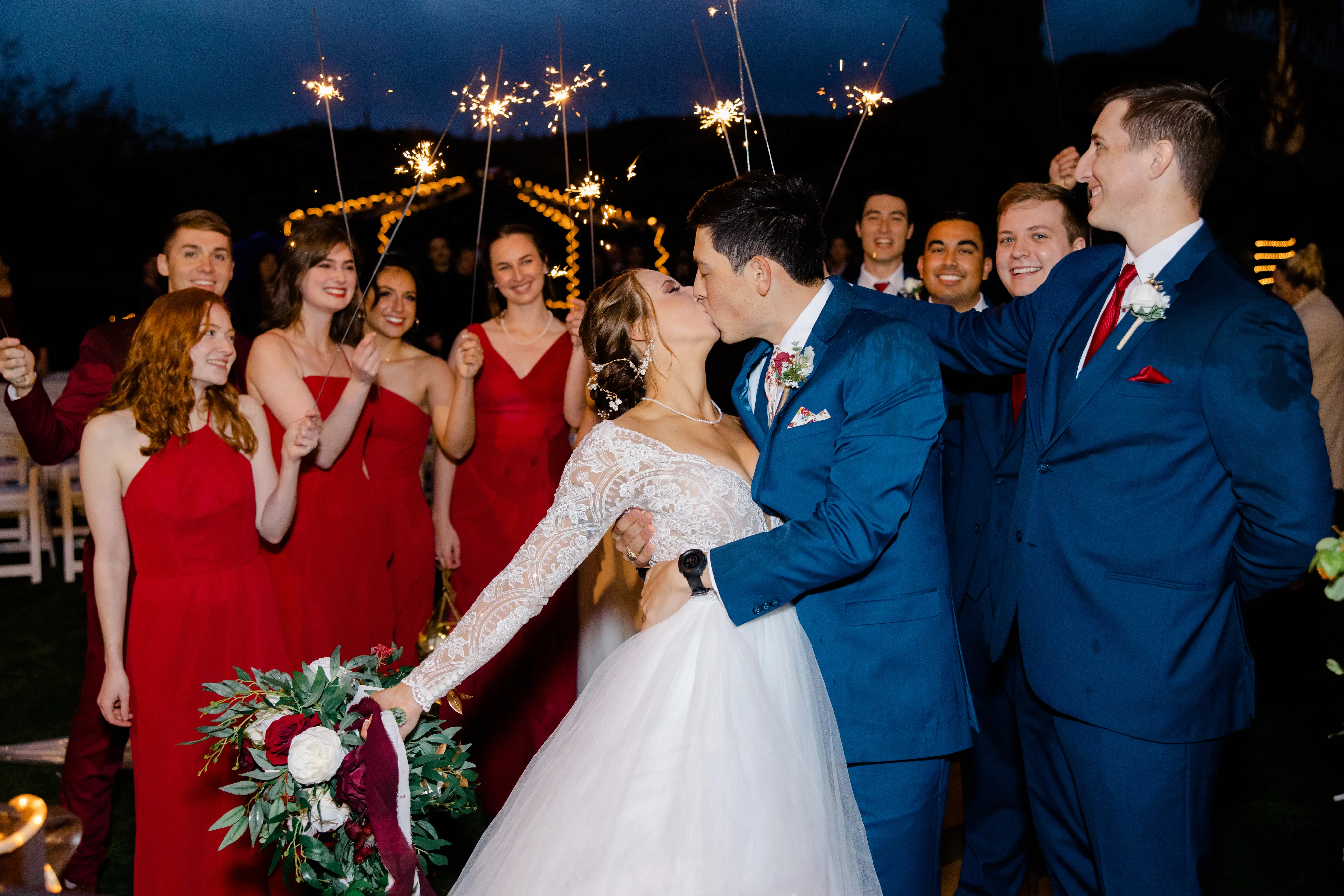 Groom Kissing Bride in Romantic Long Sleeve Ball Gown Wedding Dress with Lace Motifs on Nude Bodice and Tulle Skirt Called Mallory Dawn by Maggie Sottero