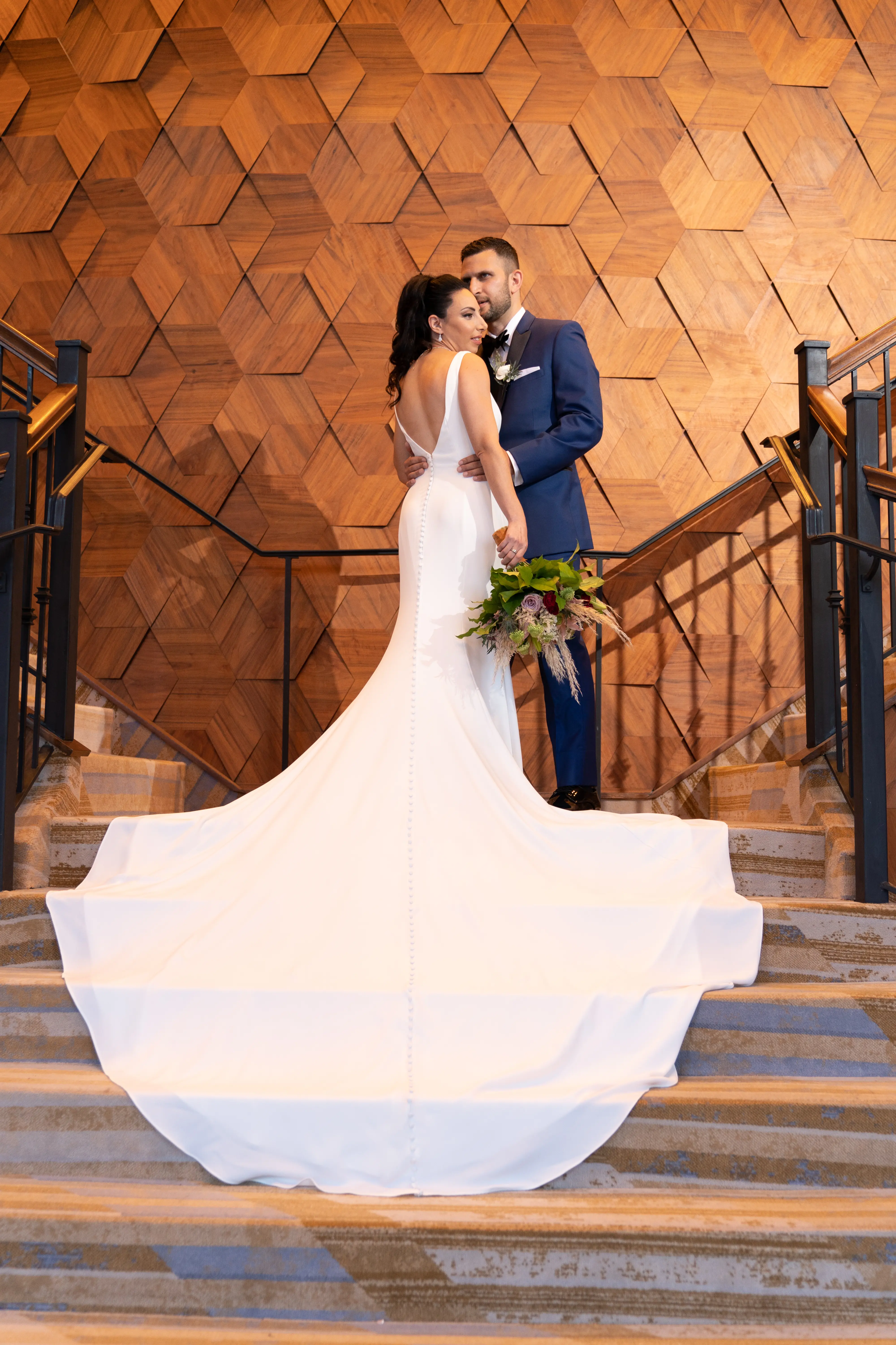 Bride with groom wearing simple fit and flare crepe wedding dress
