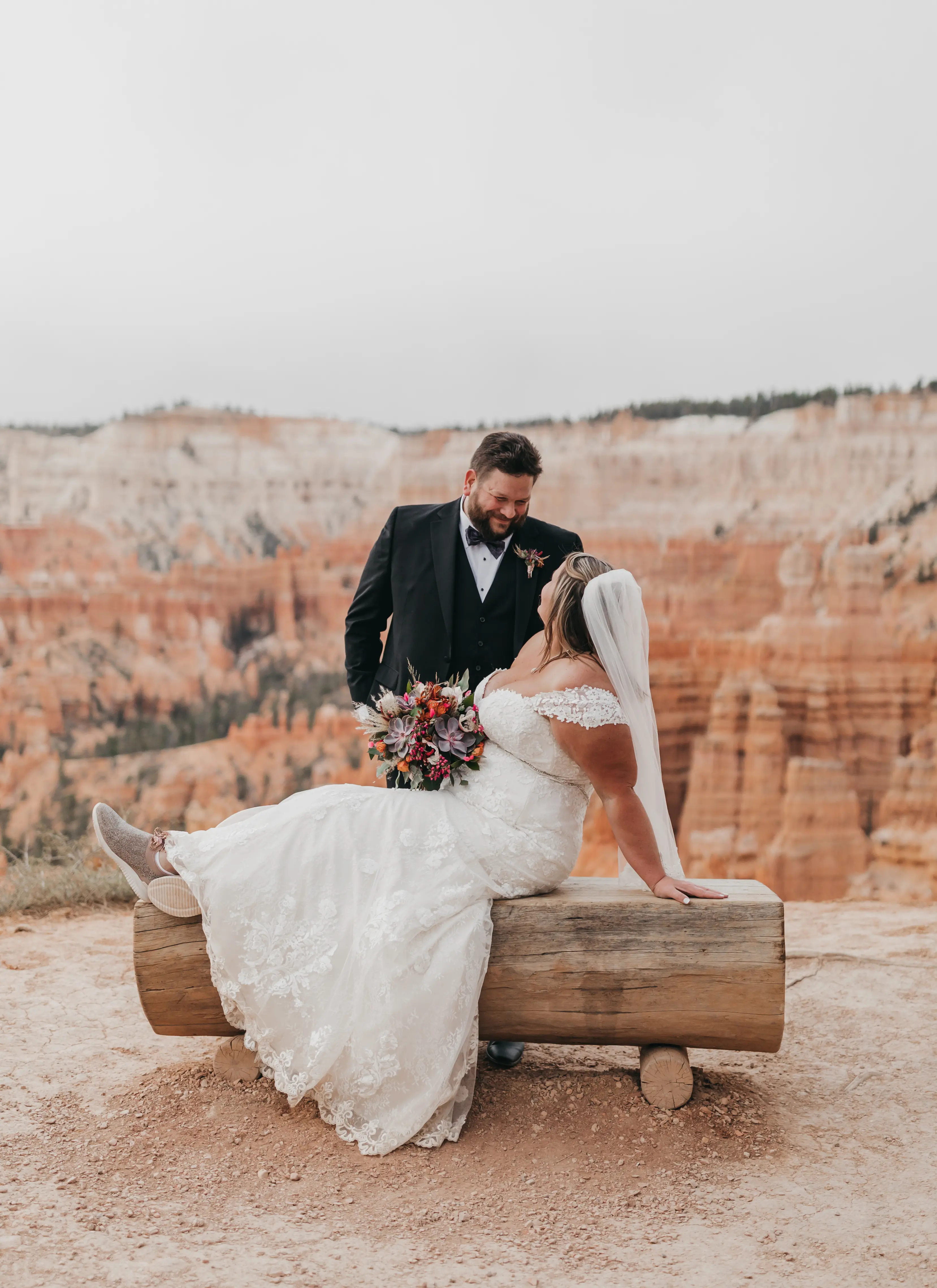 bride with groom in corset back fit and flare wedding dress