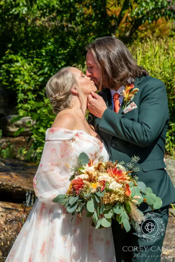 Bride wearing Nerida wedding dress by Sottero and Midgley while kissing her husband