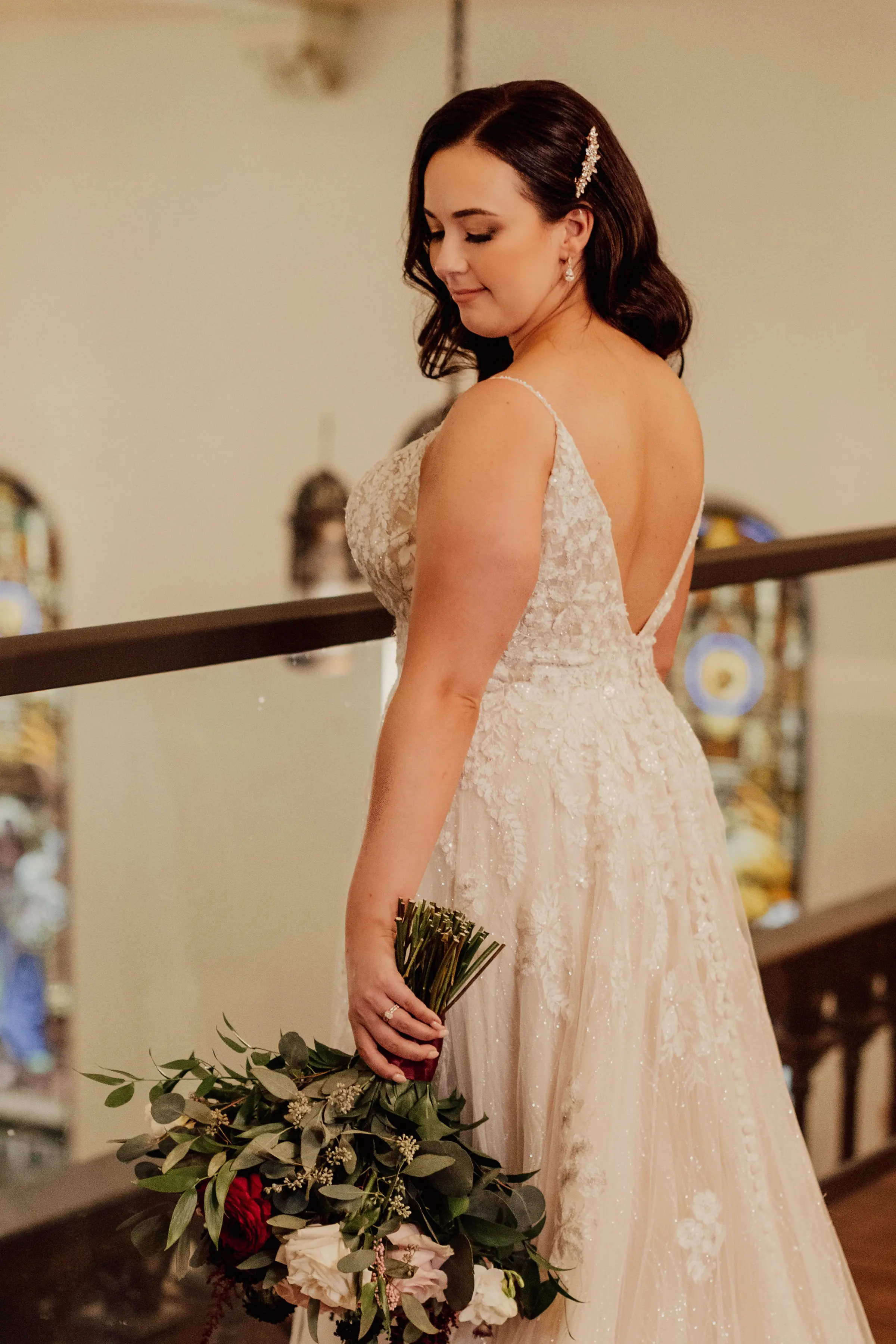 Bride Wearing Floral Lace Wedding Gown Called Laramie By Sottero And Midgley Holding A REd And White Rose Bouquet