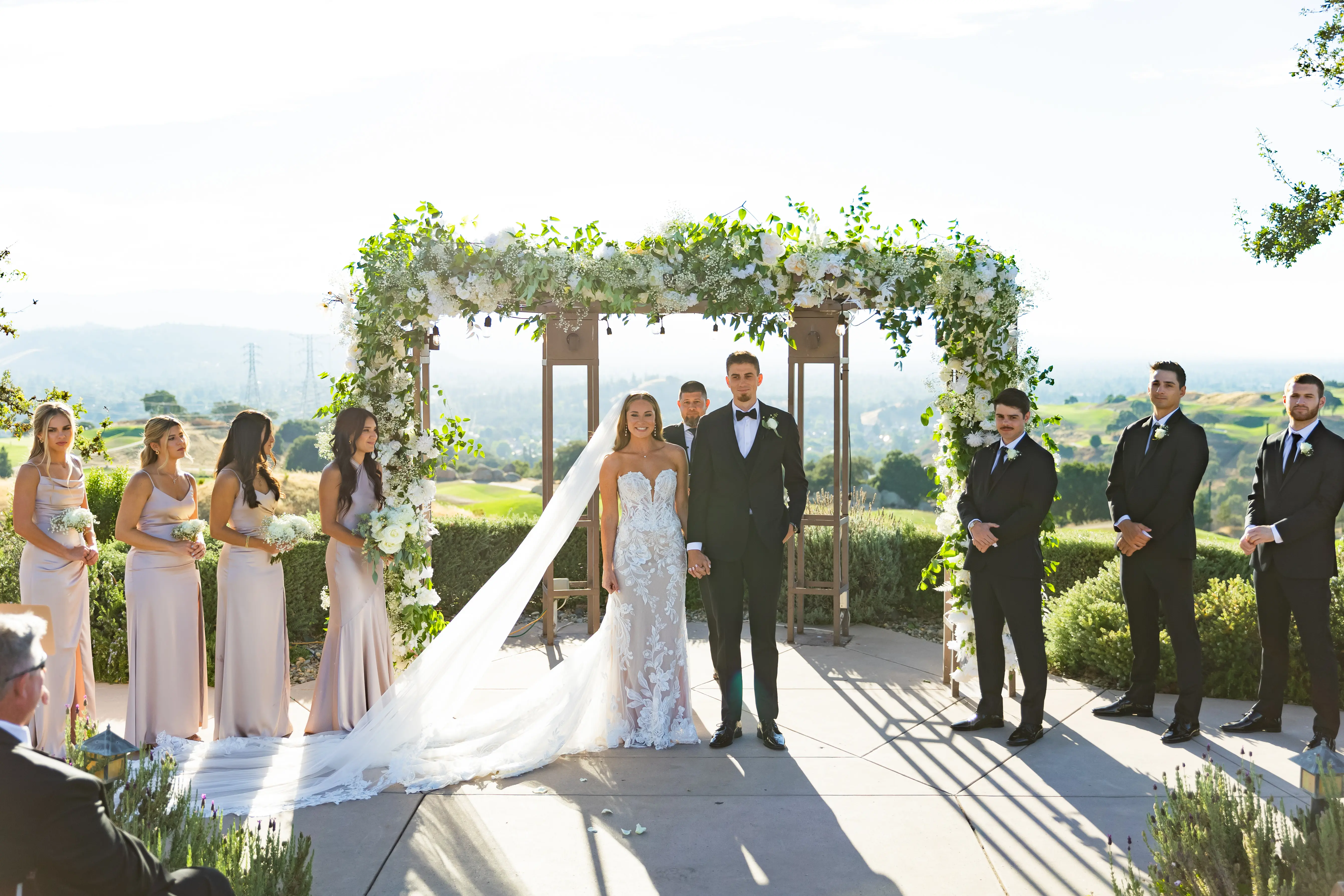 Bride Wearing Lace Fit-n-flare Wedding Dress Called Nyjah By Sottero And Midgley Standing With Groom At The Altar