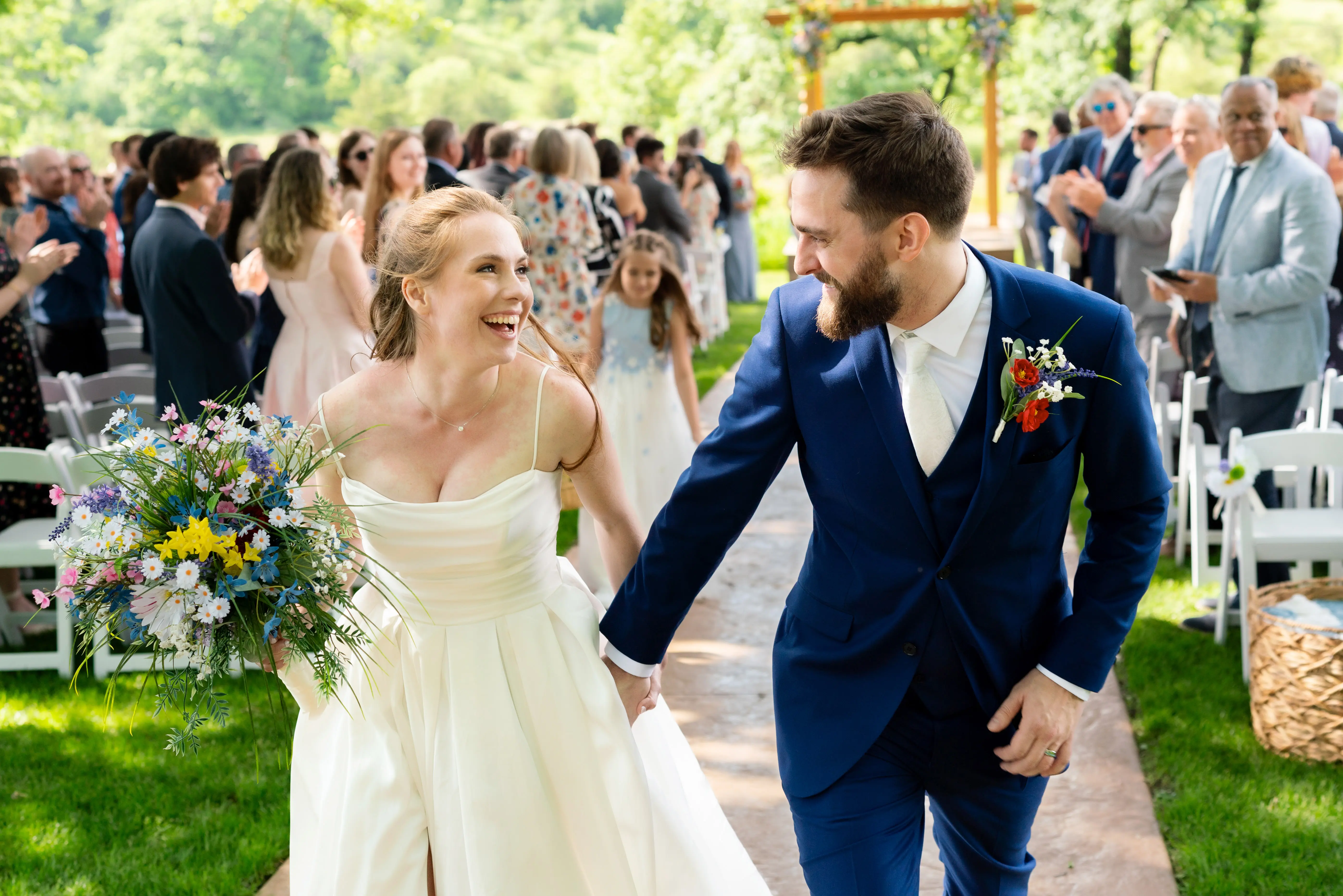 Bride wearing Scarlet by Maggie Sottero running with her husband