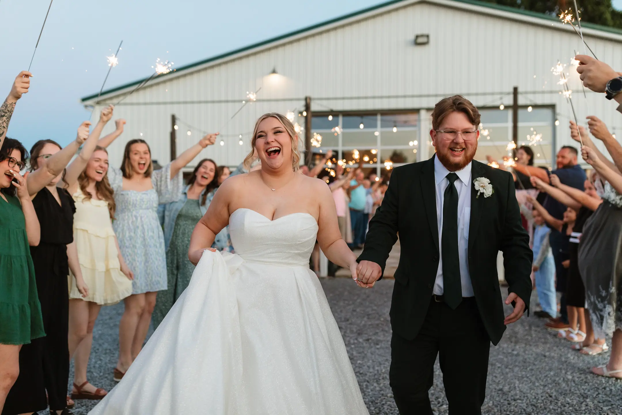 Bride wearing Anniston by Maggie Sottero exiting the reception with her husband