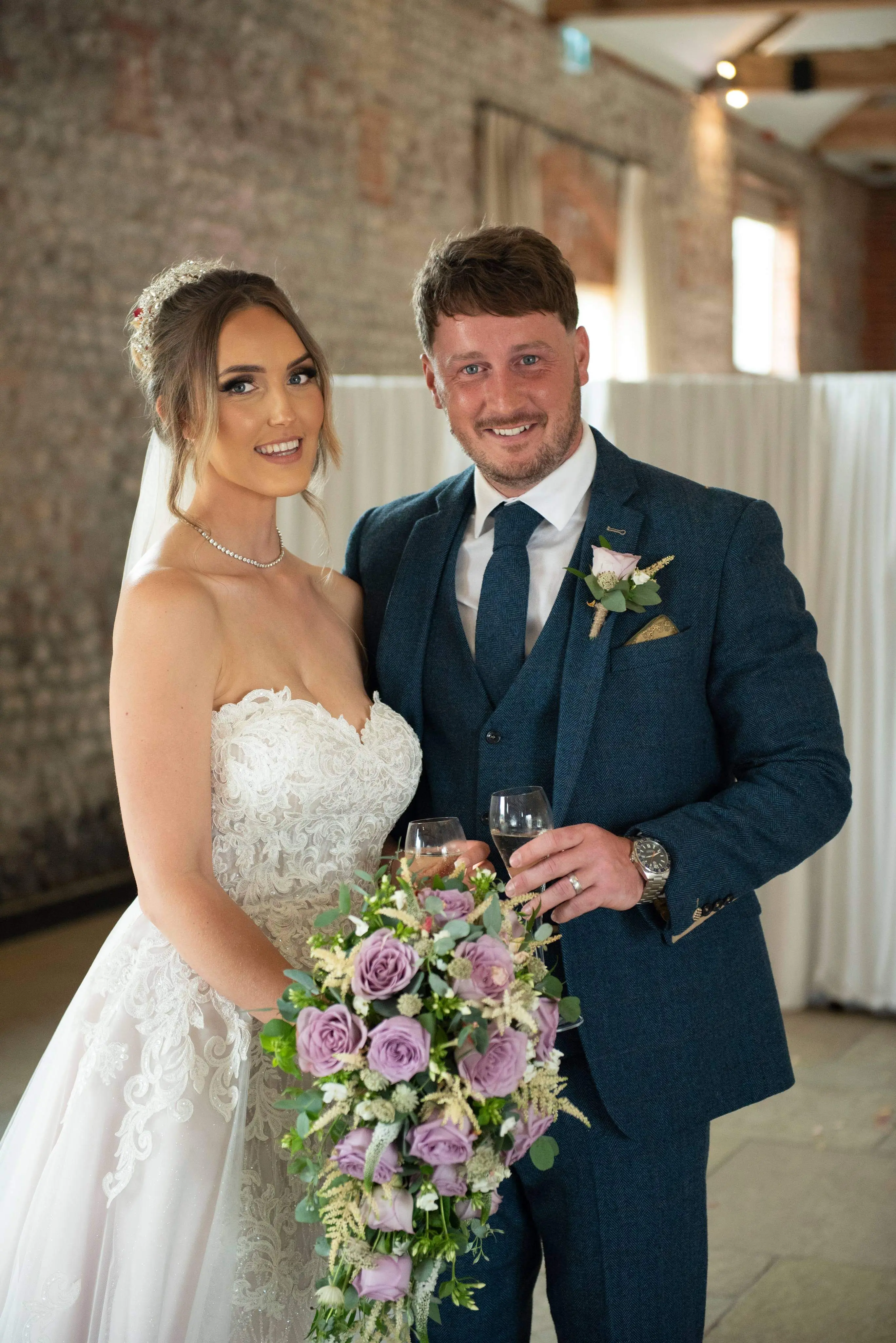 bride with groom in lacy mermaid wedding dress