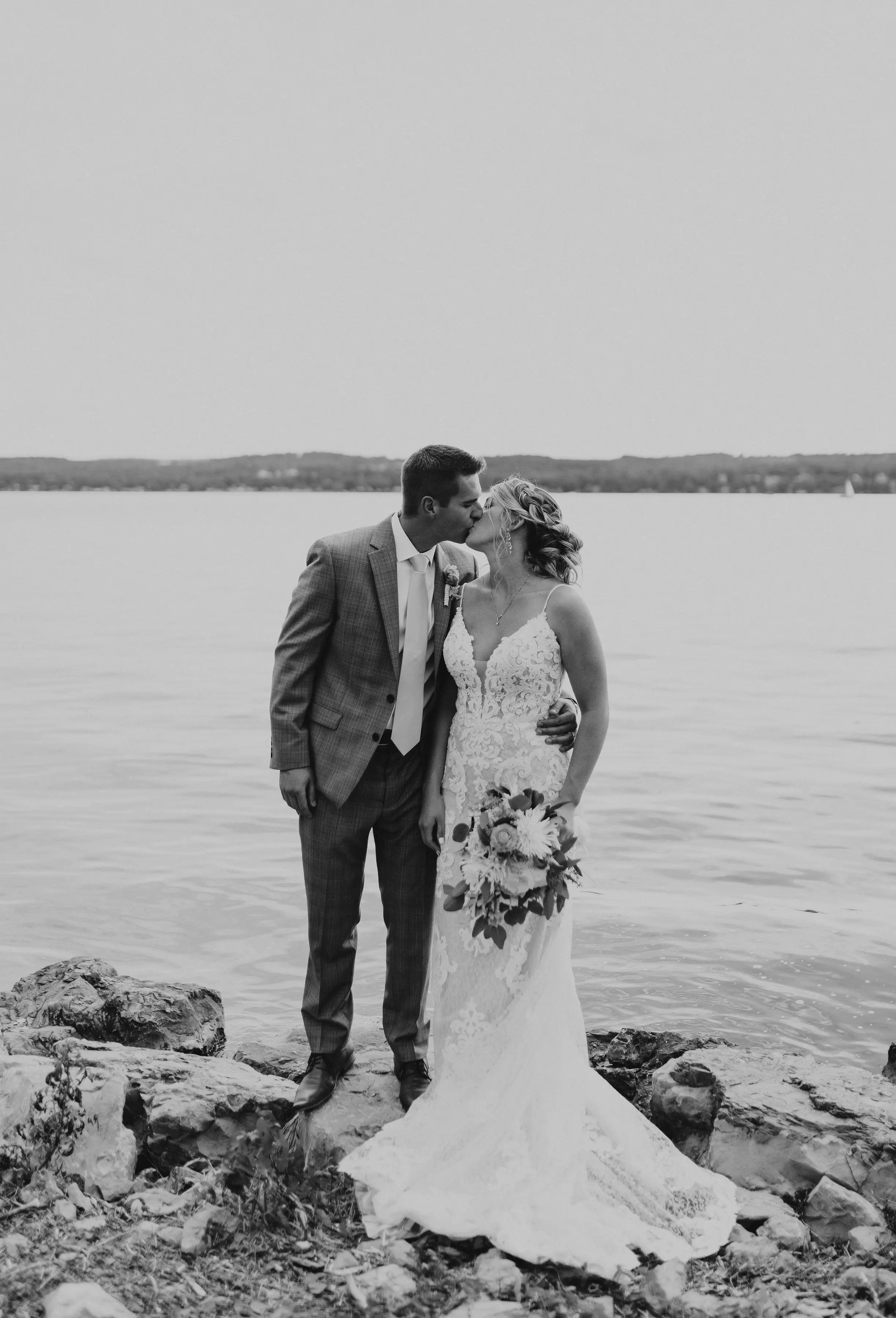 Bride Wearing Lace Sexy Wedding Dress Called Tuscany Lynette By Maggie Sottero With Groom By A Lake