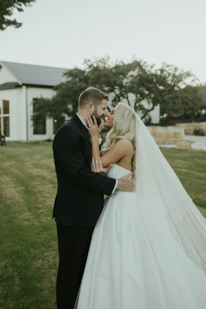 Bride wearing Derrick by Maggie Sottero kissing her husband