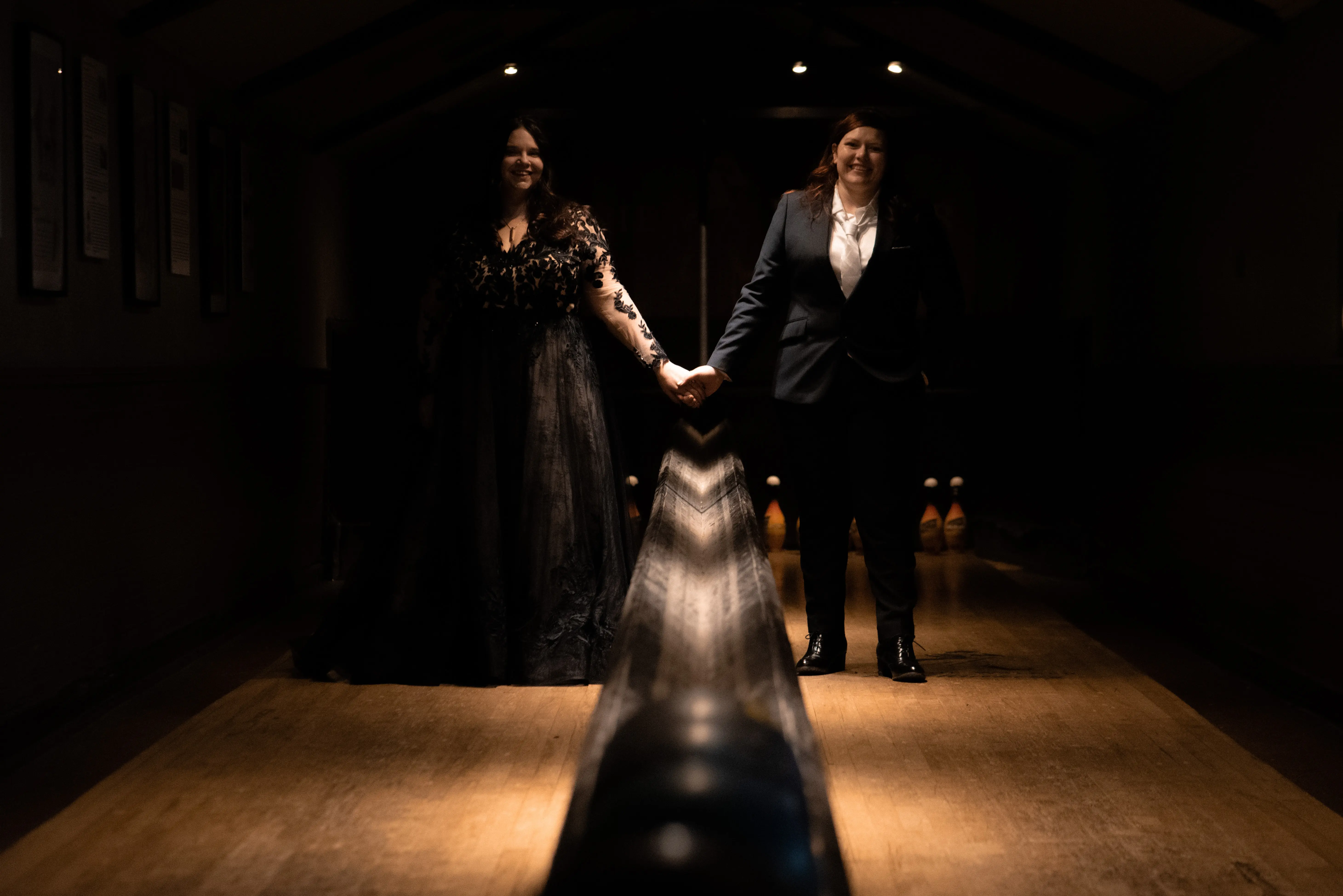 Bride Wearing Black A-Line Wedding Dress Called Zander By Sottero And Midgley Holding Hands With Bride
