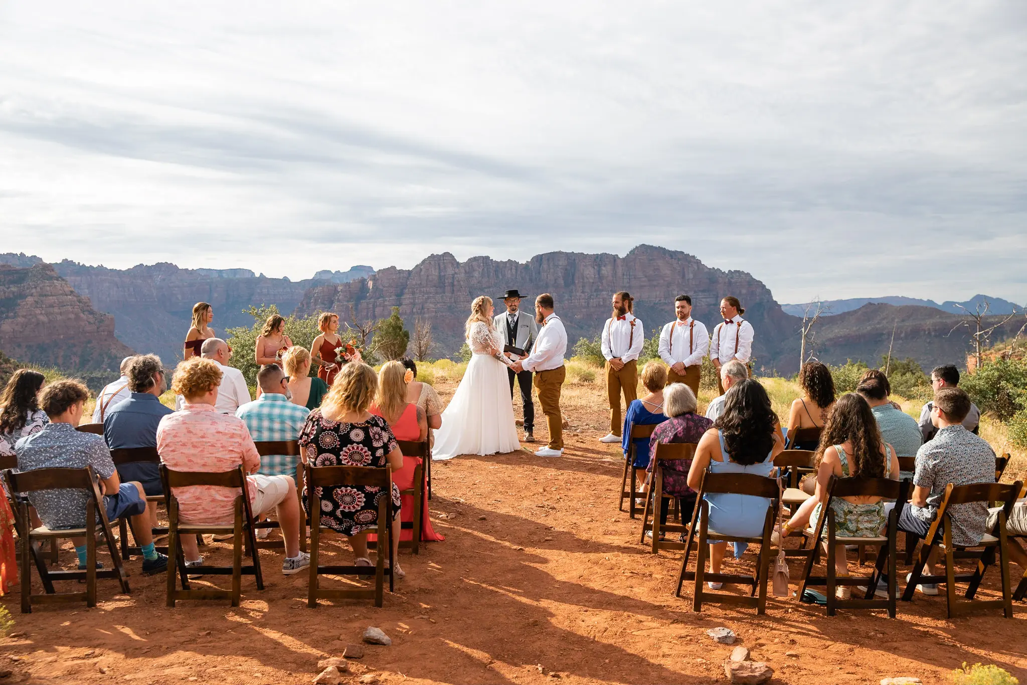 Real Bride in Long Sleeved, Thigh-High Slit Wedding Dress Named Lorraine by Rebecca Ingram at the Alter