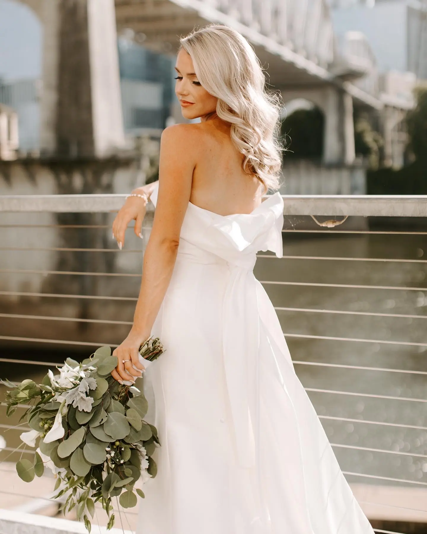 Bride Wearing Unique Strapless Wedding Dress With Beautiful Back Bow Mitchell By Maggie Sottero