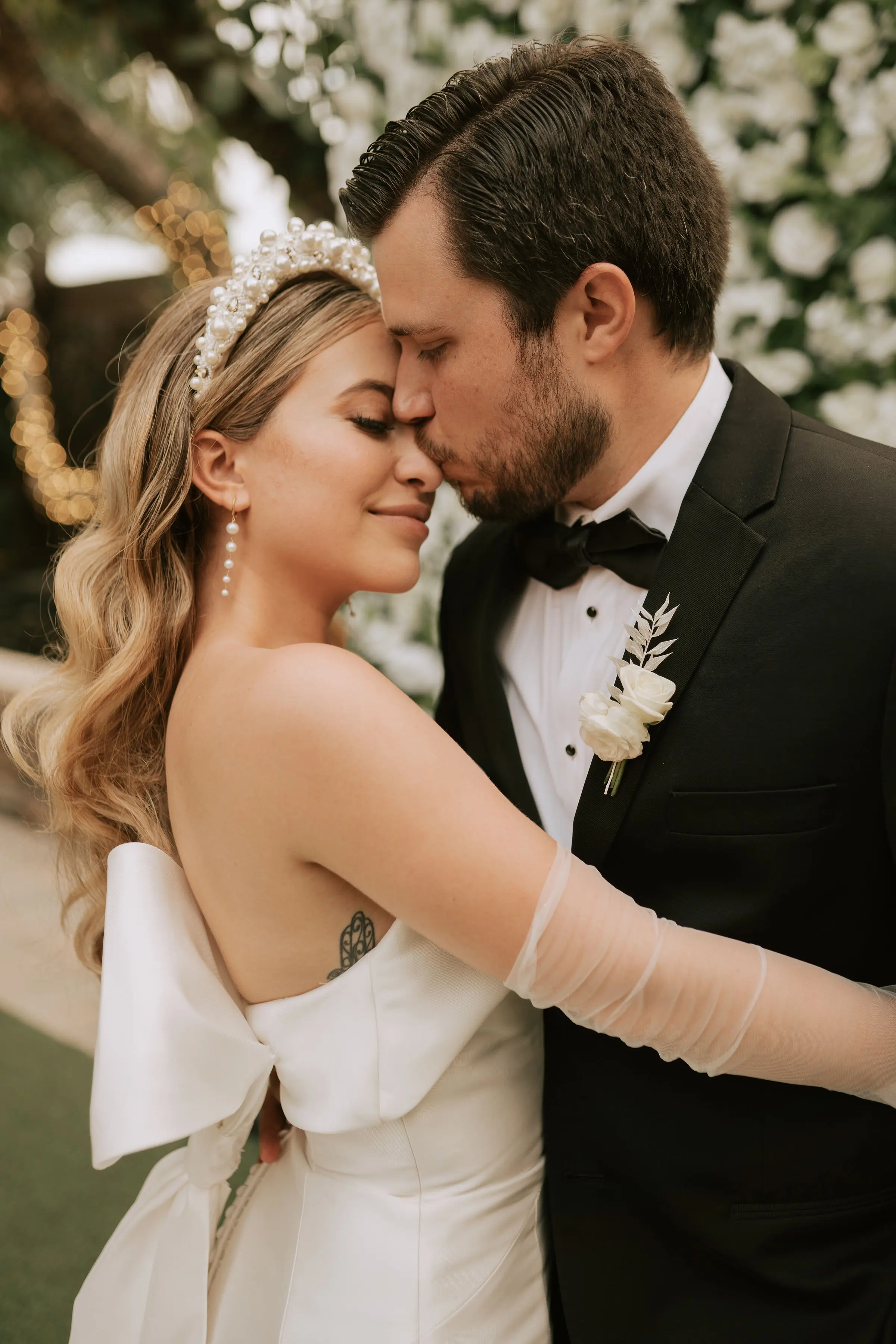 Groom With Bride Wearing Simple Sheath Satin Dress With Back Bow Mitchell By Maggie Sottero