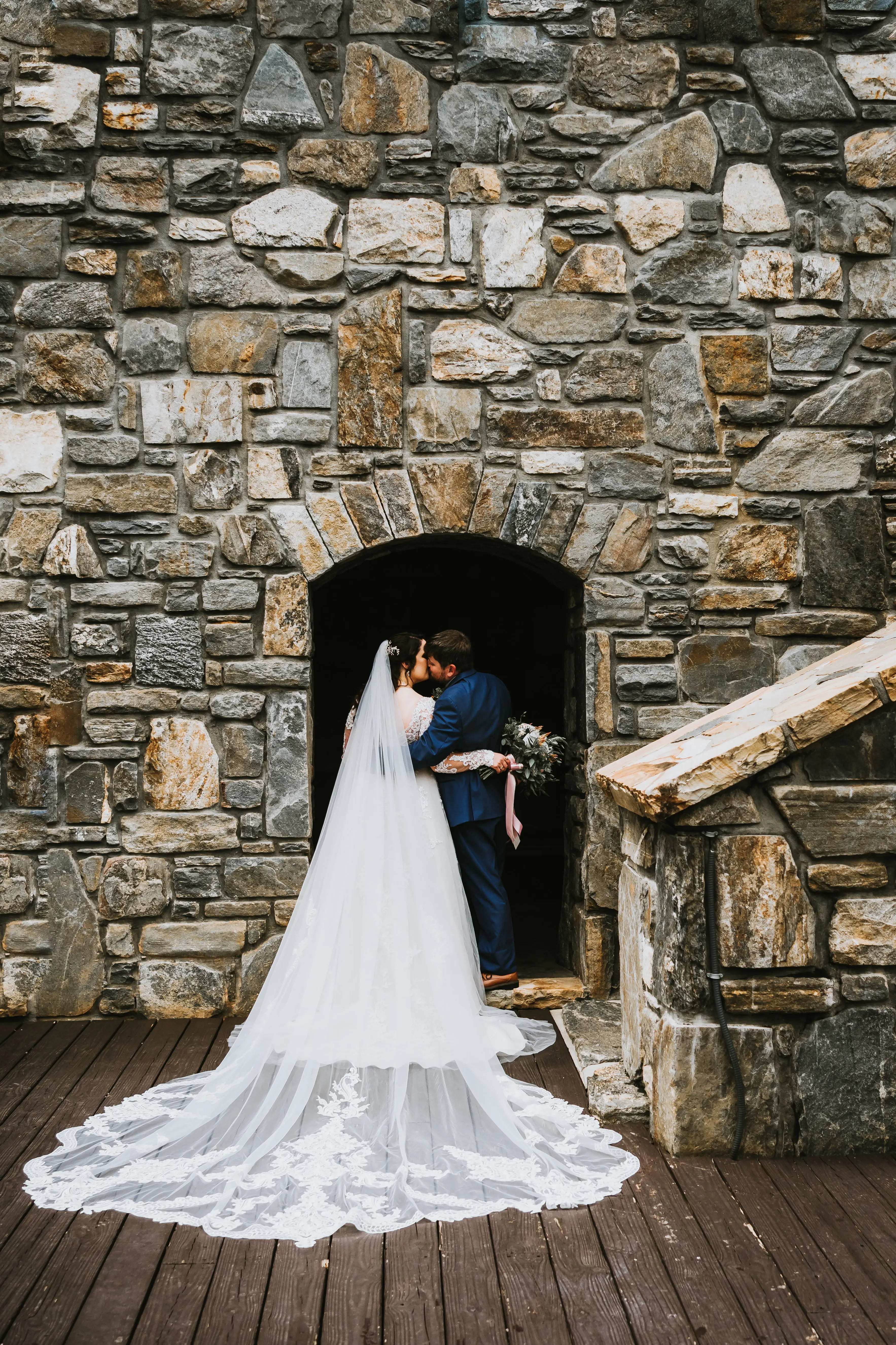 Bride Wearing Shimmery Princess Bridal Gown Called Tiffany By Maggie Sottero Kisses Groom With Veil