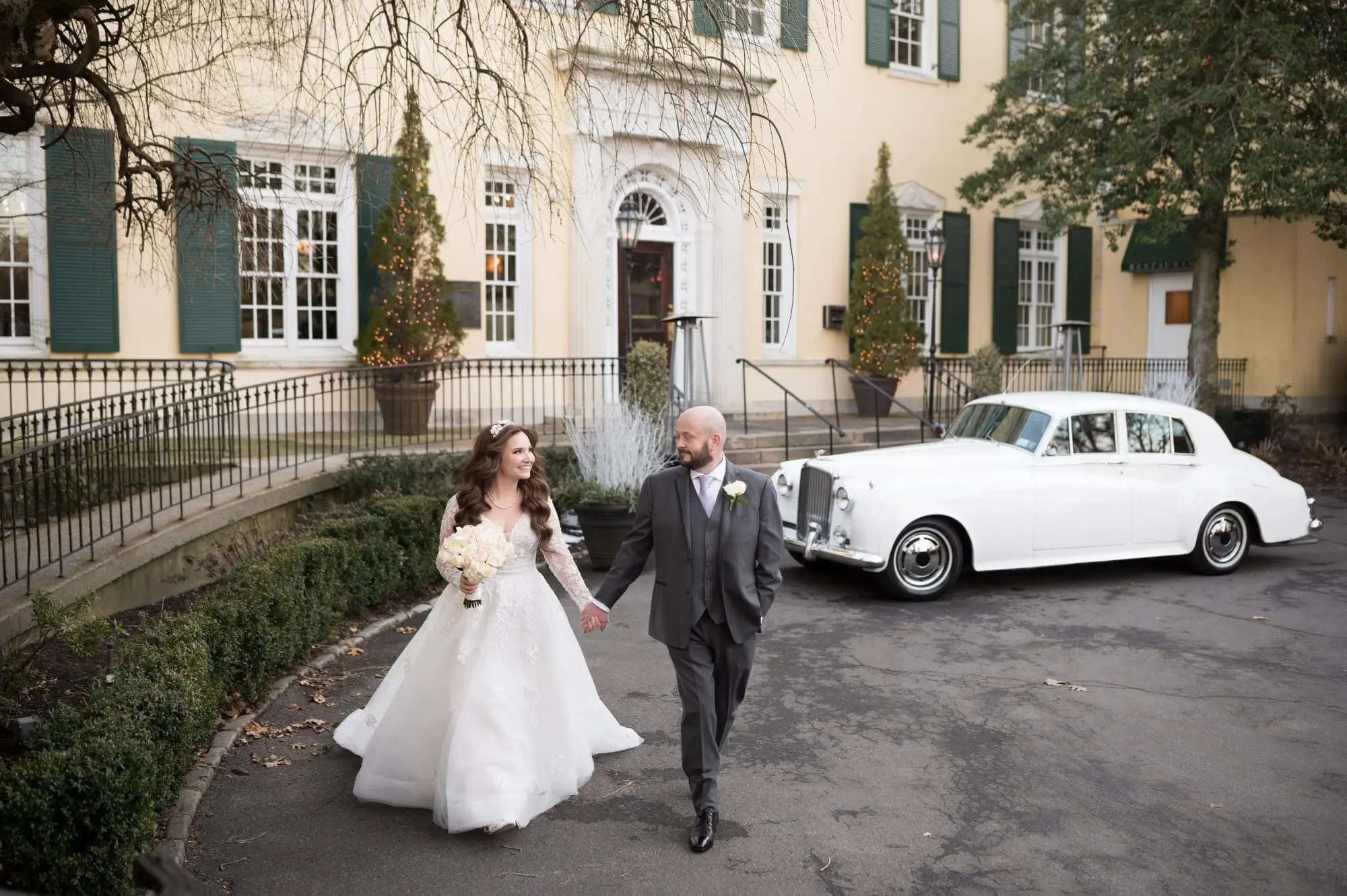 Groom Holding Hands with Bride in Illusion Sleeve A-Line Wedding Dress Inspired by Vintage Royalty called Raphael by Maggie Sottero