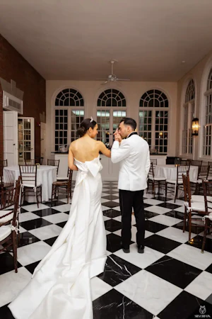 Bride And Groom Standing Together. Bride Wearing Unique Strapless Wedding Gown With Statement Bow Called Mitchell By Maggie Sottero