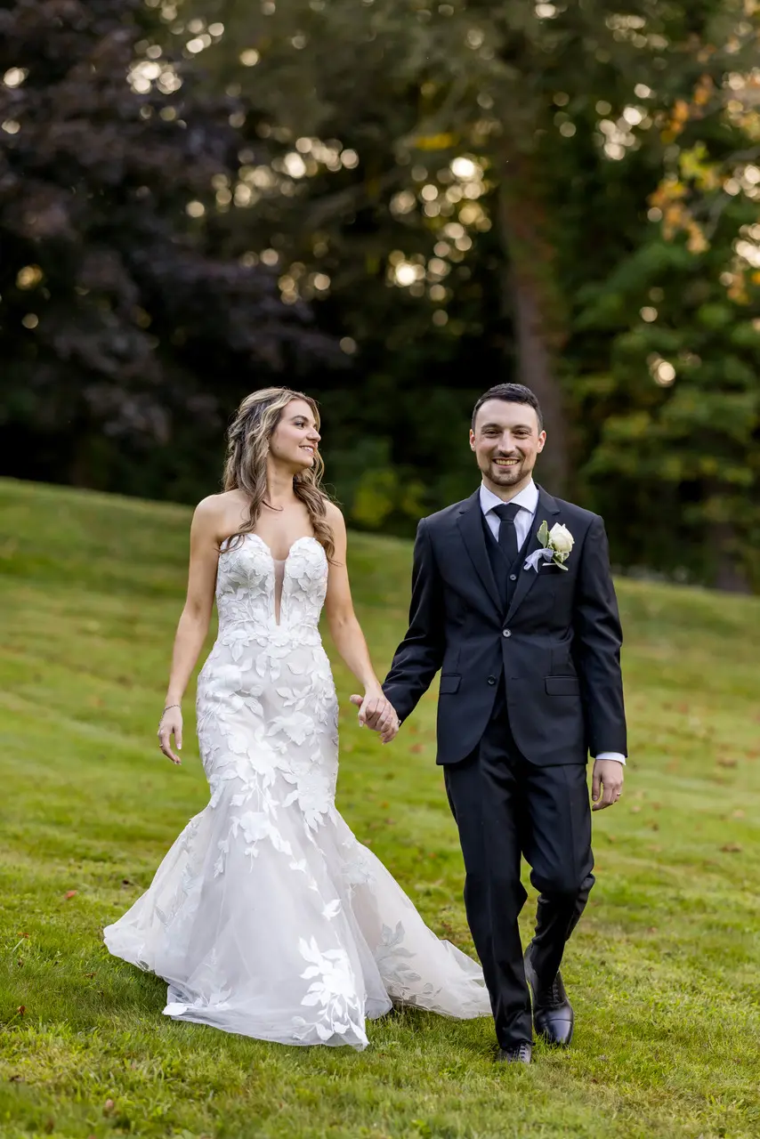 Bride wearing Hattie Marie by Rebecca Ingram holding hands with her husband