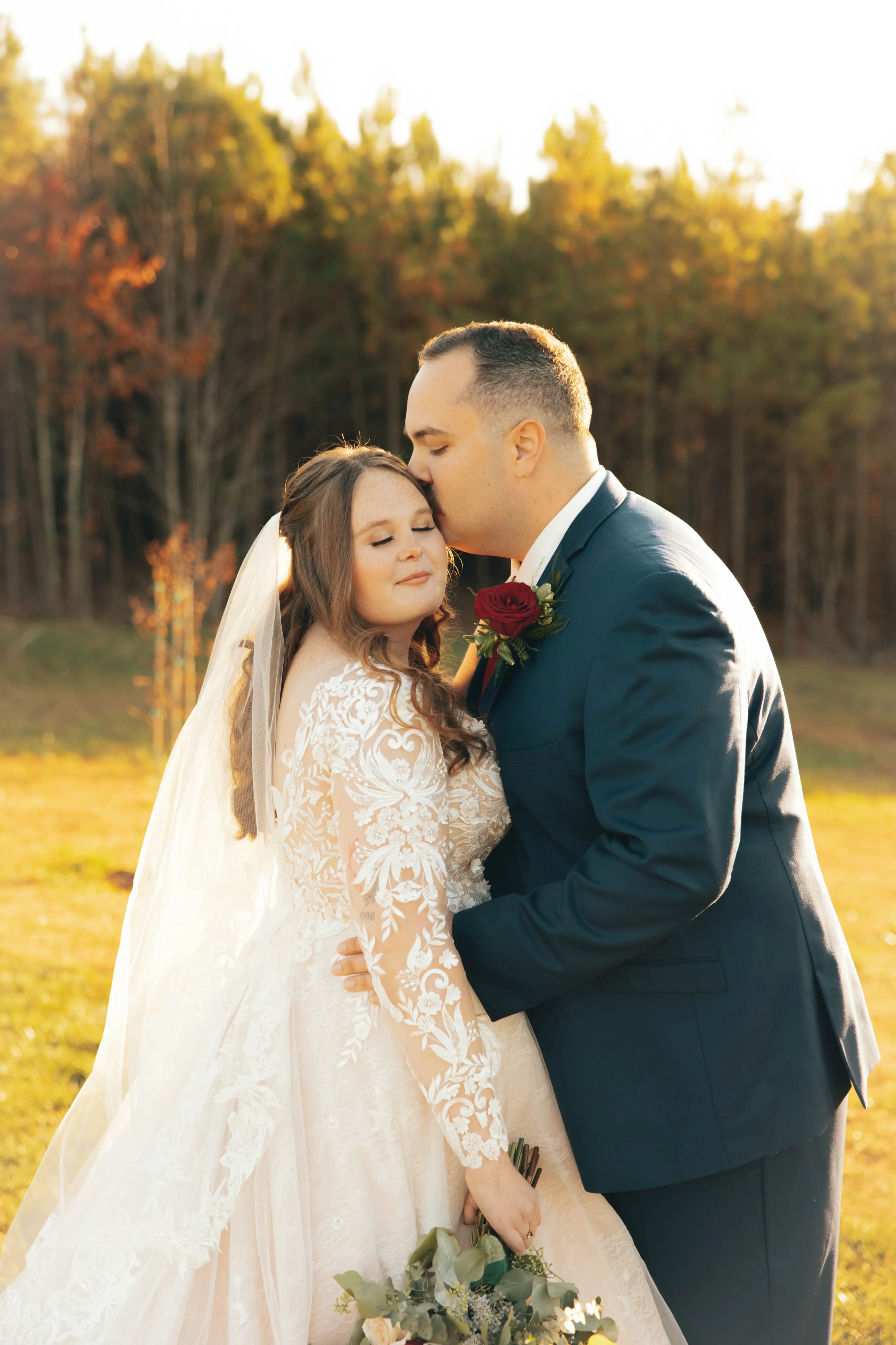 Bride wearing Zander wedding gown by Sottero and Midgley being kissed by her husband